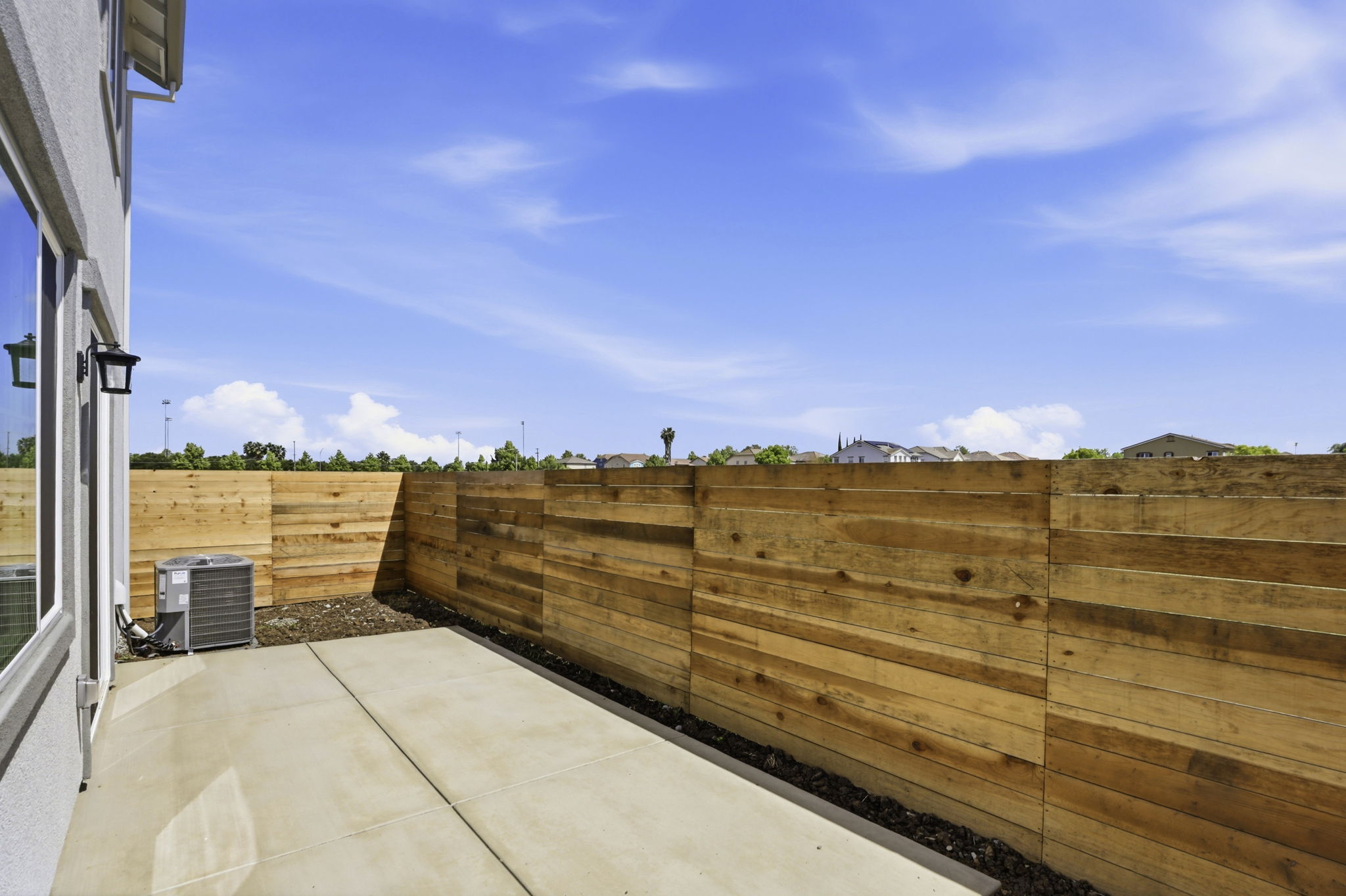 A wooden fence with a person standing on it.