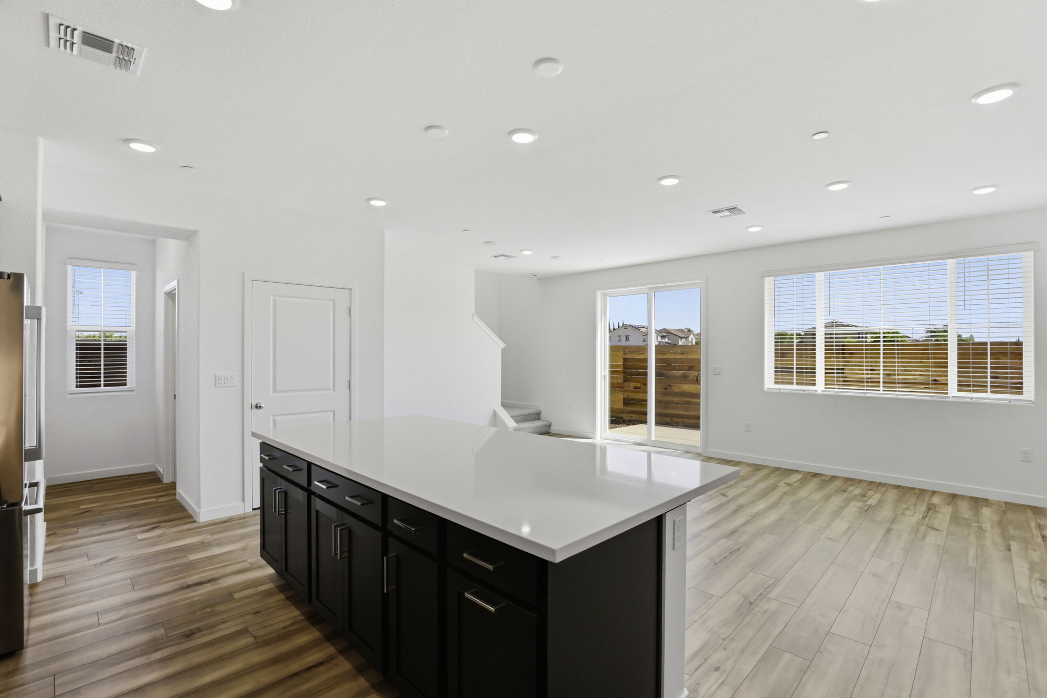 A kitchen with black cabinets.