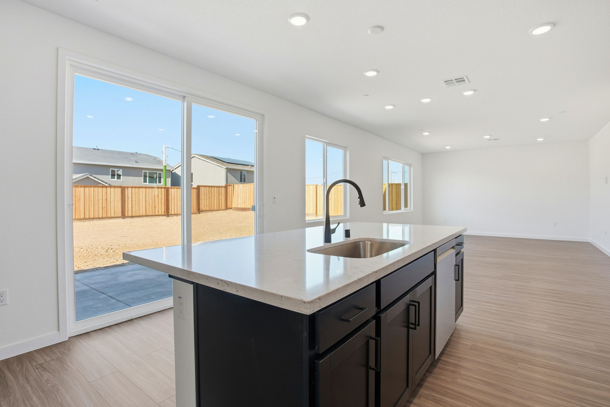 A kitchen with a large window.