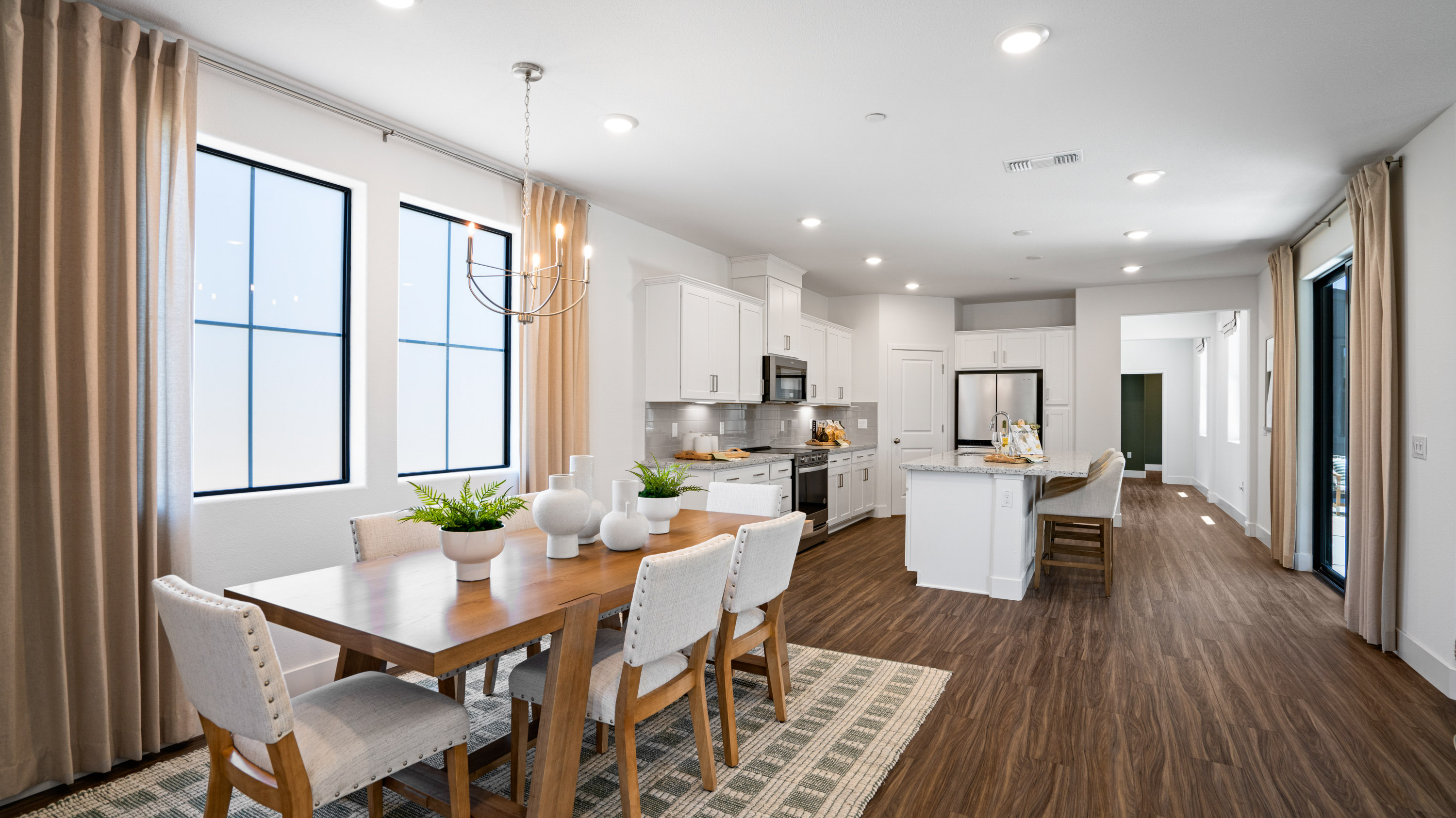 A large kitchen with a dining table.