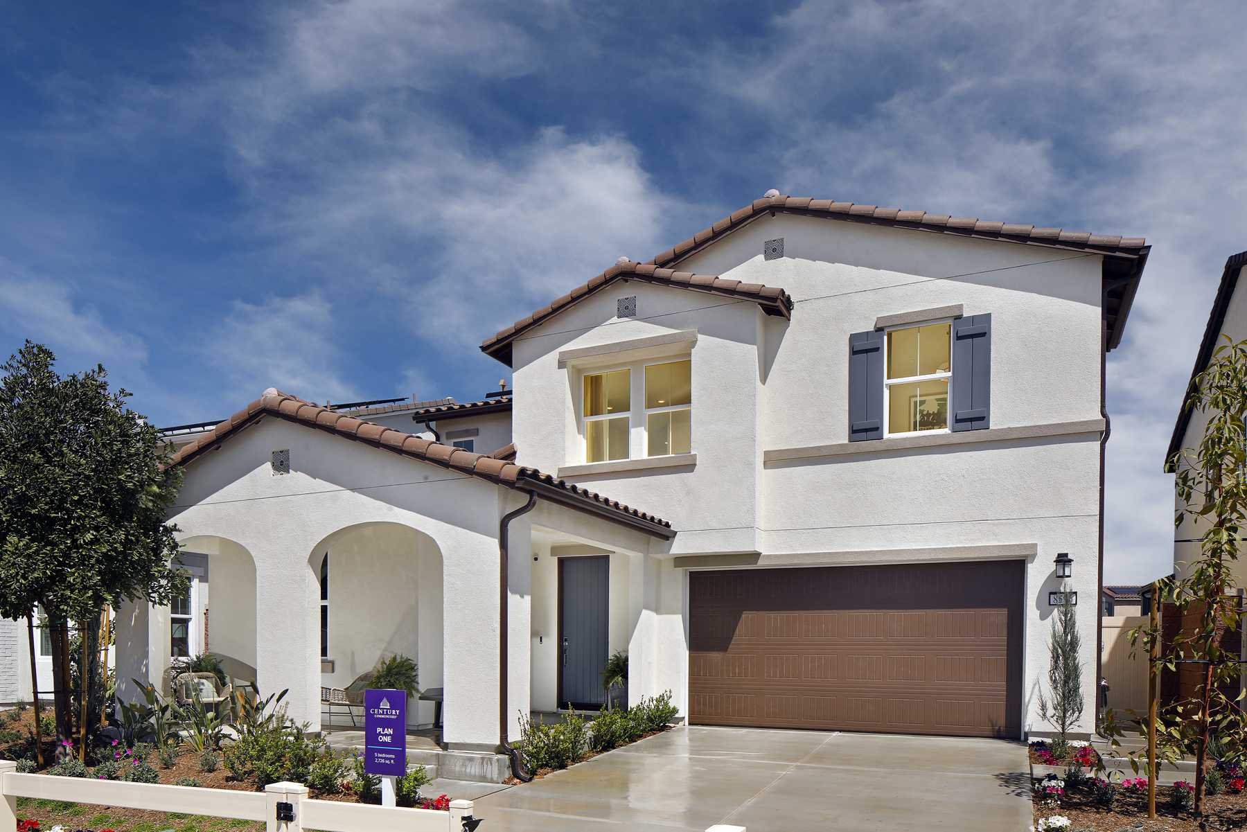A white house with a garage.
