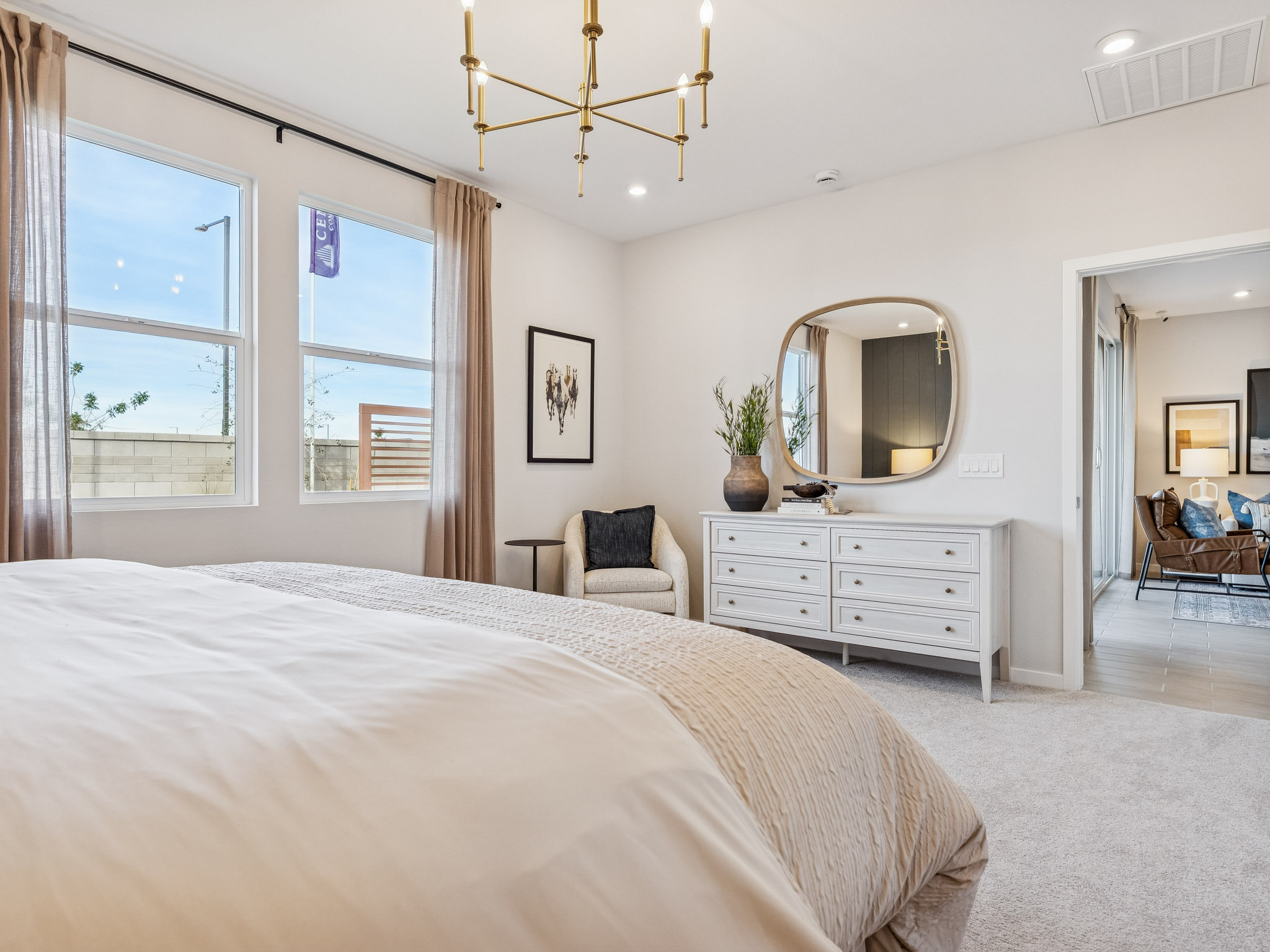 A bedroom with a large mirror.