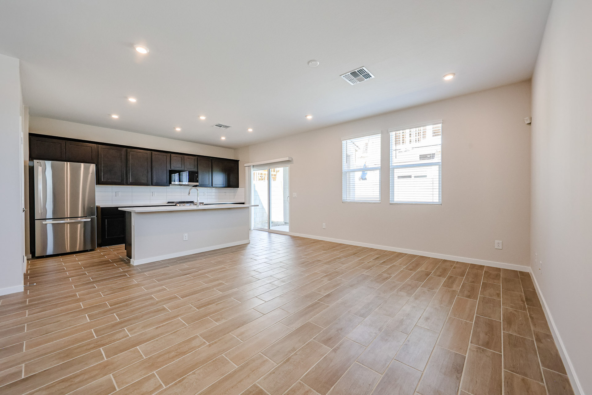 A large kitchen with wood floors.