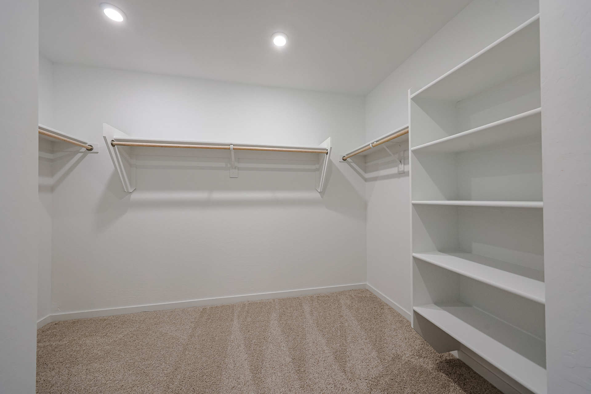 A white room with a white shelf.
