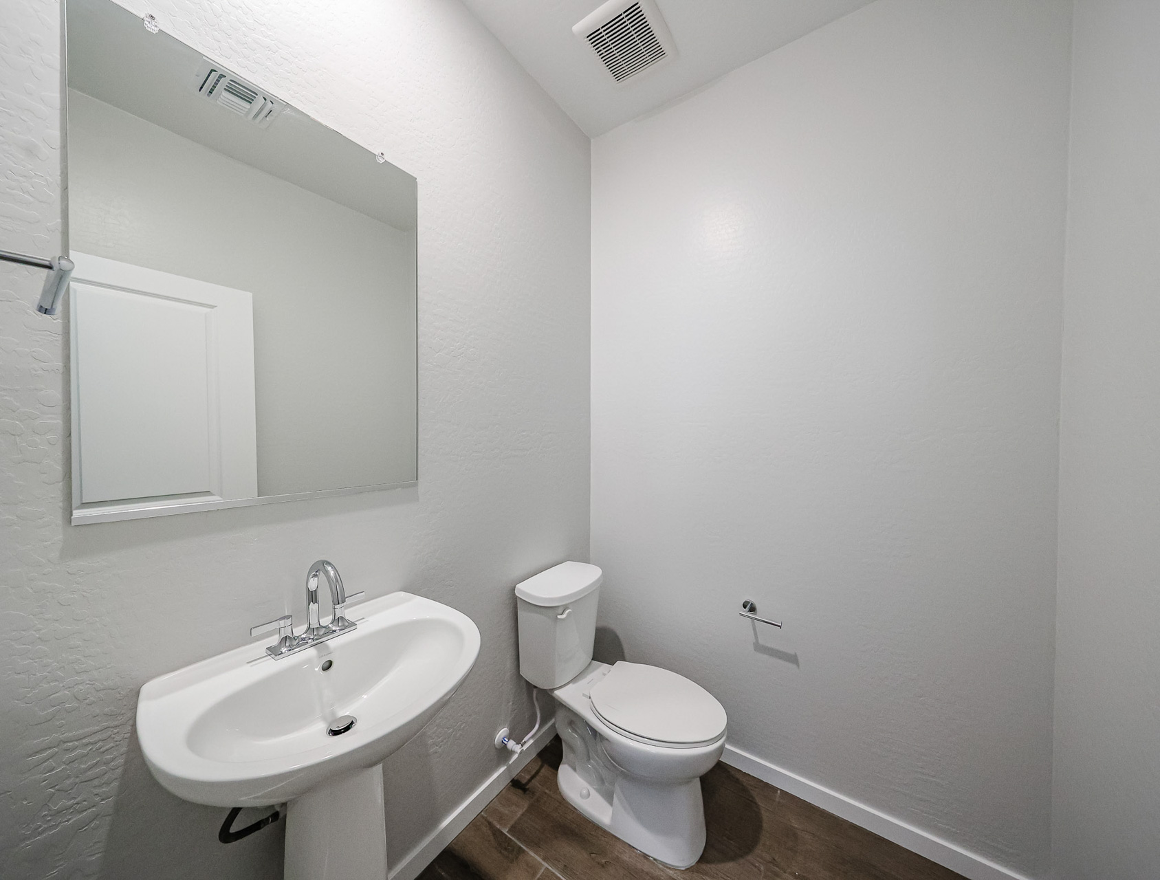 A bathroom with a toilet and sink.