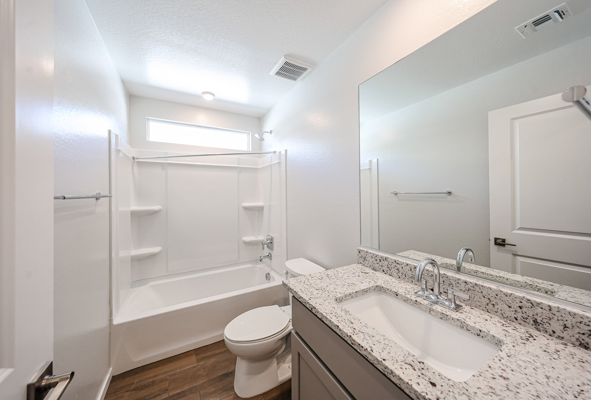 A bathroom with a marble countertop.