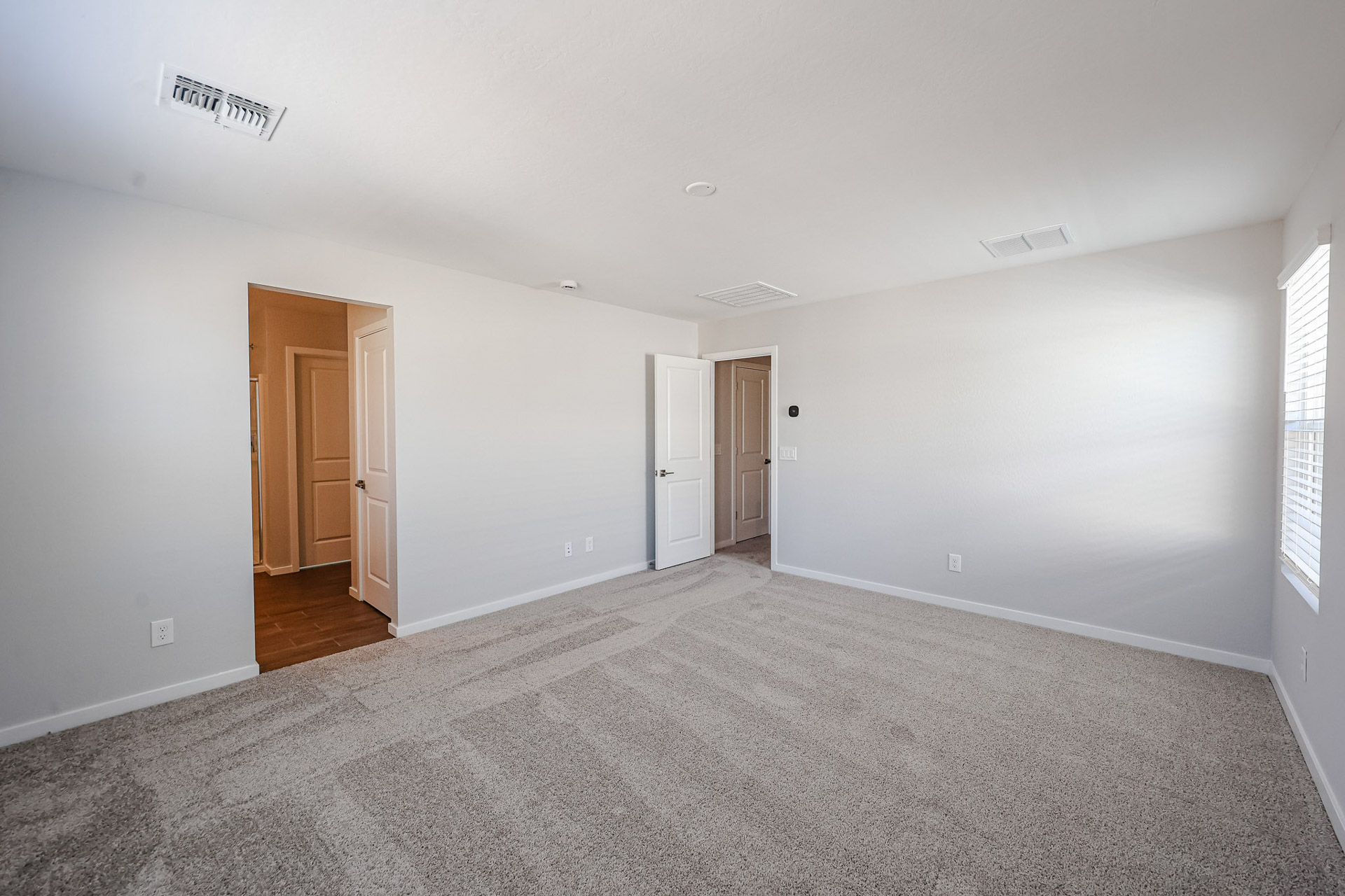 A room with white walls and a wood floor.