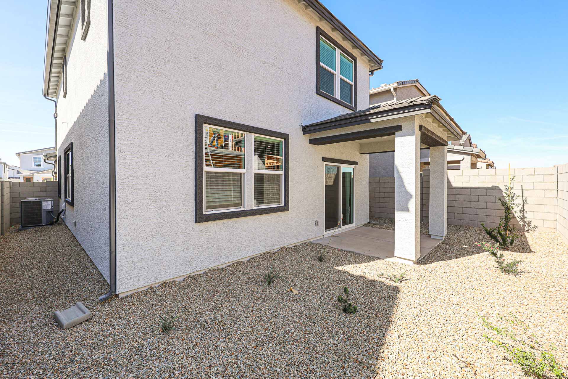 A house with a stone driveway.