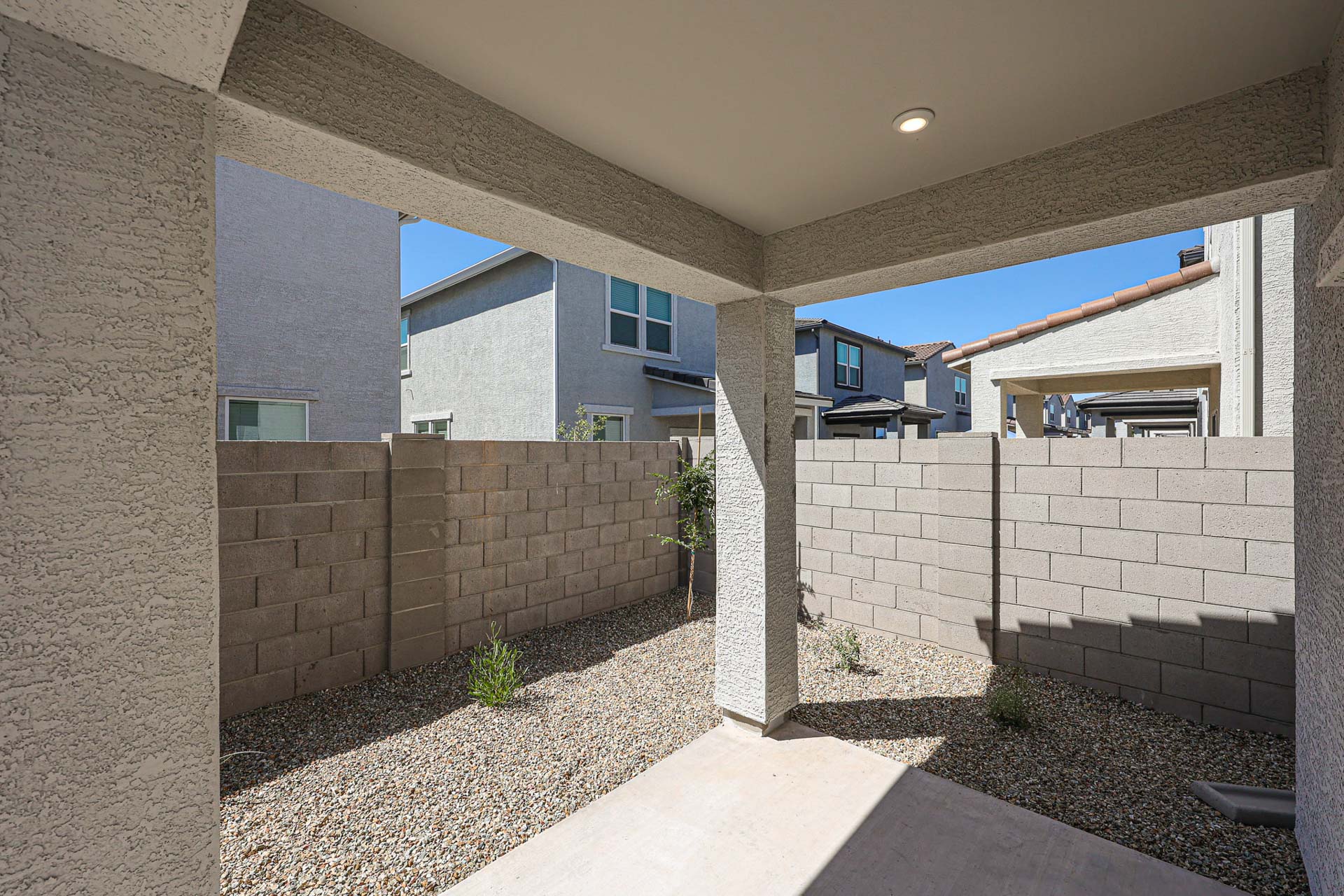 A stone patio with a stone wall and a stone patio with a stone patio and a brick wall.