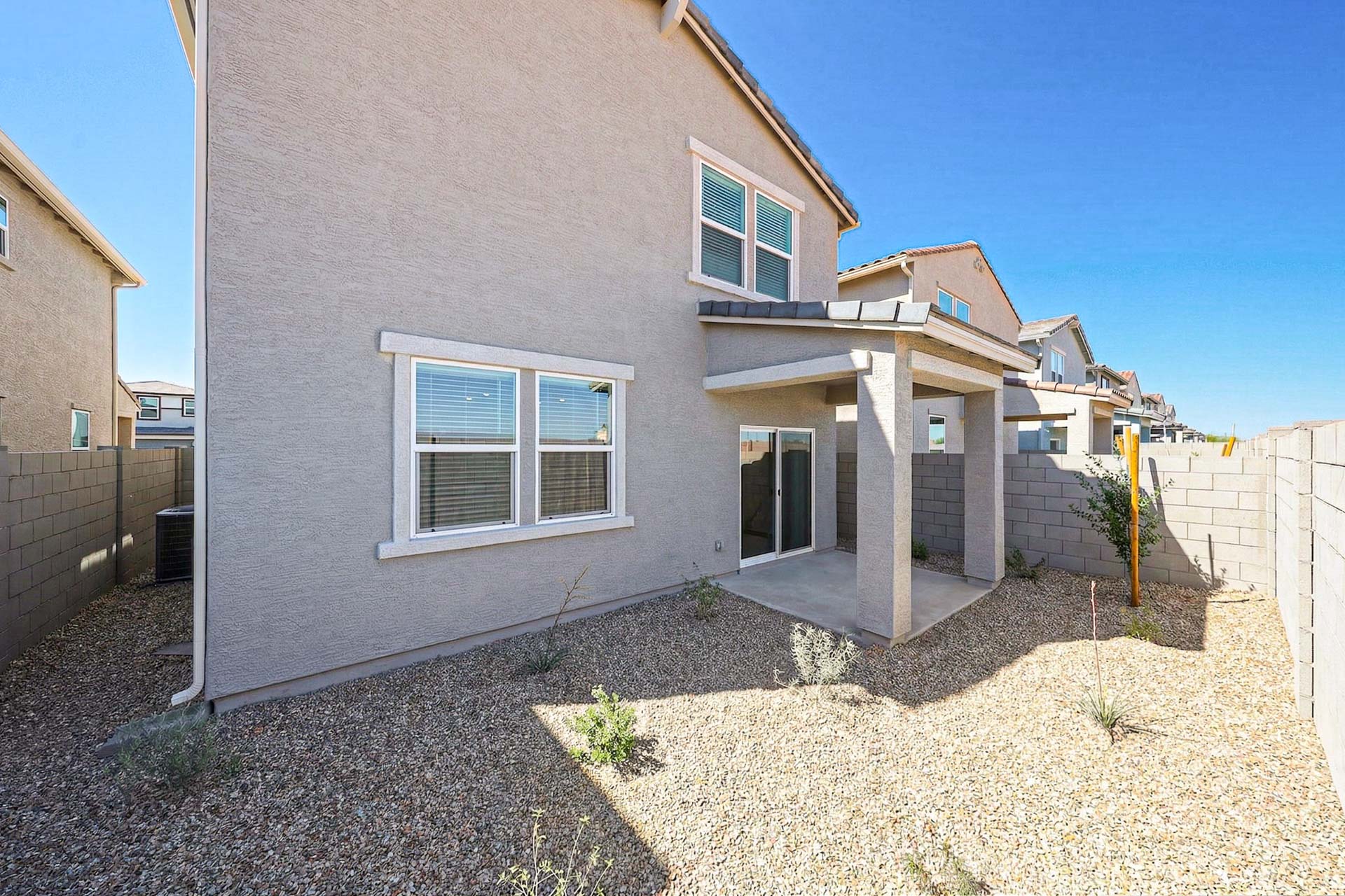 A house with a stone patio.