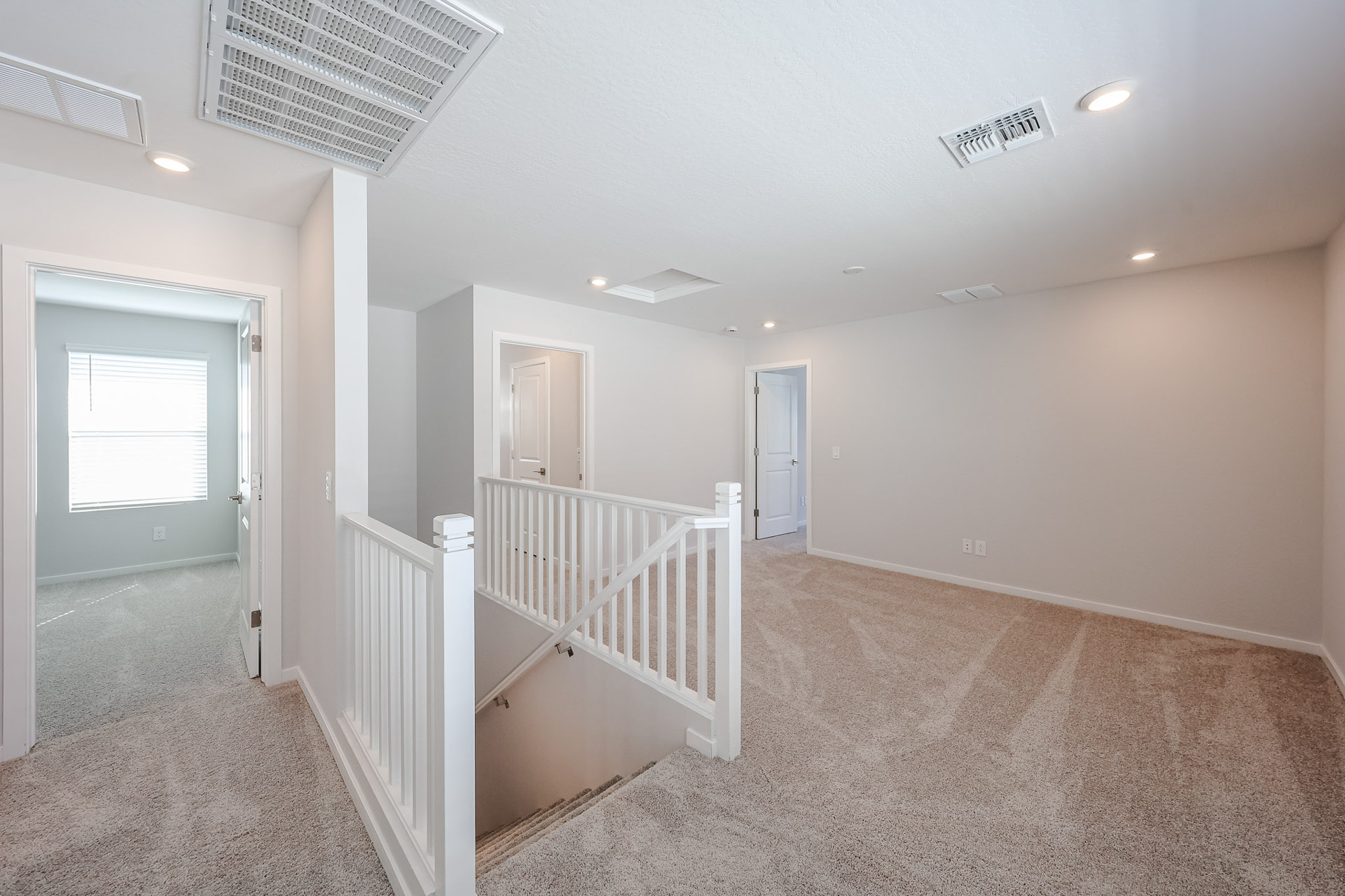 A hallway with white railings.