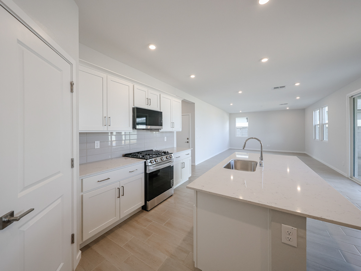 A kitchen with white cabinets.