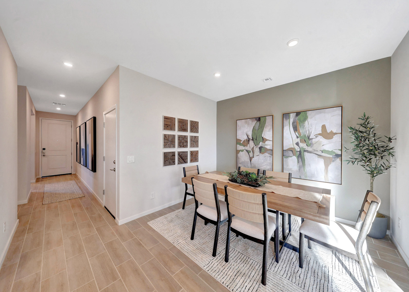 A dining room with a table and chairs.