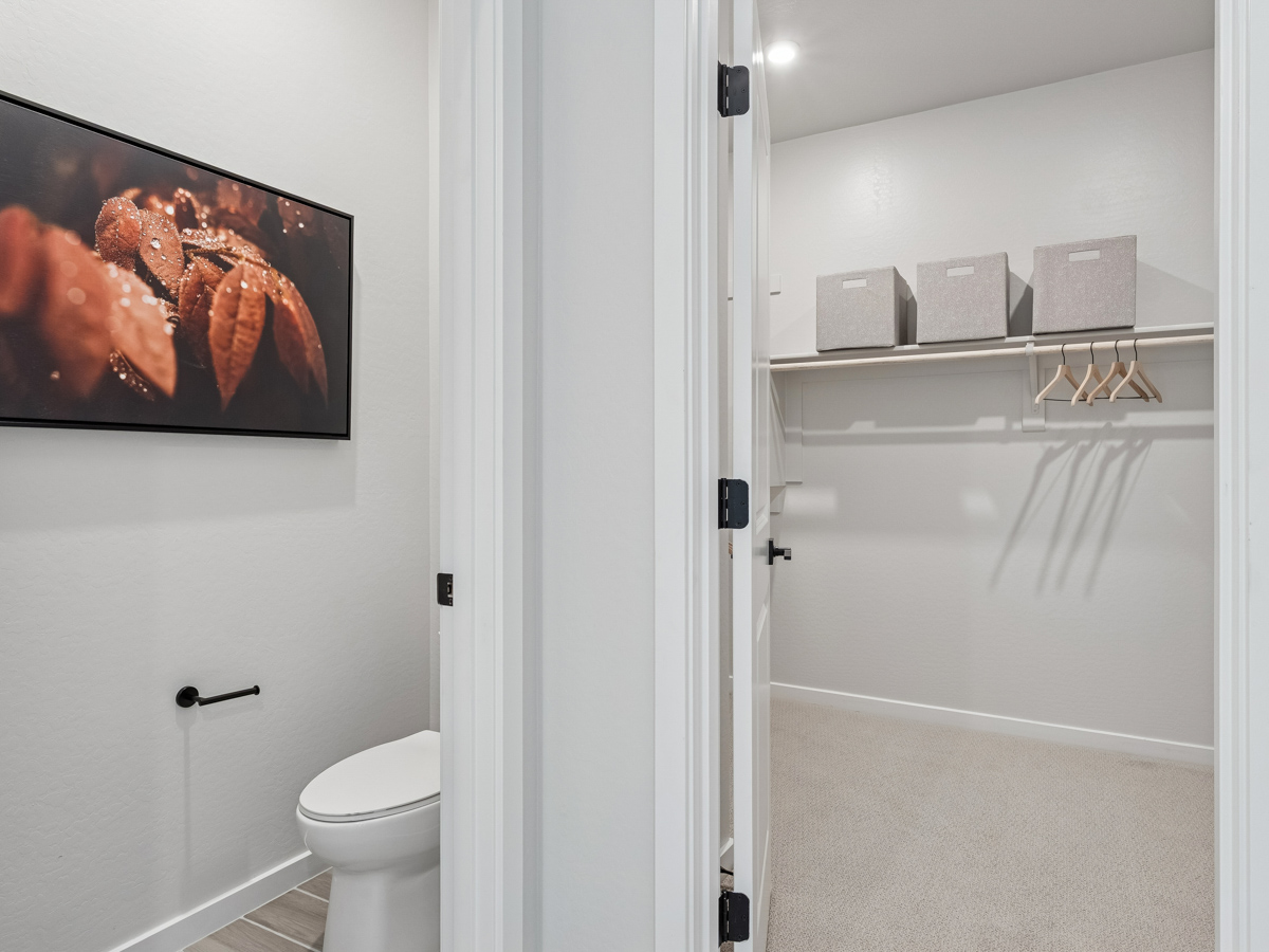 A bathroom with a shower unit and toilet.