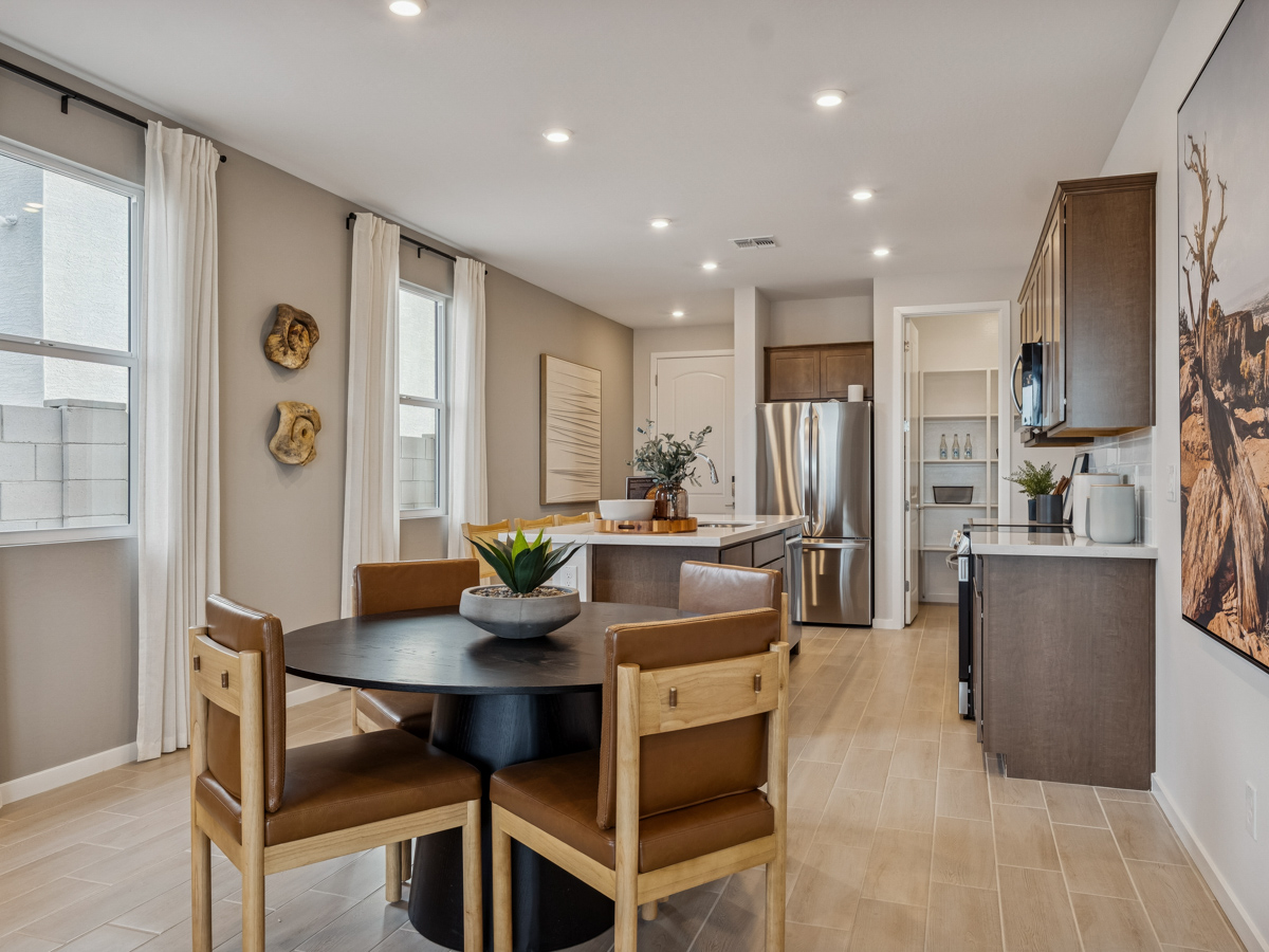 A kitchen with a dining table.
