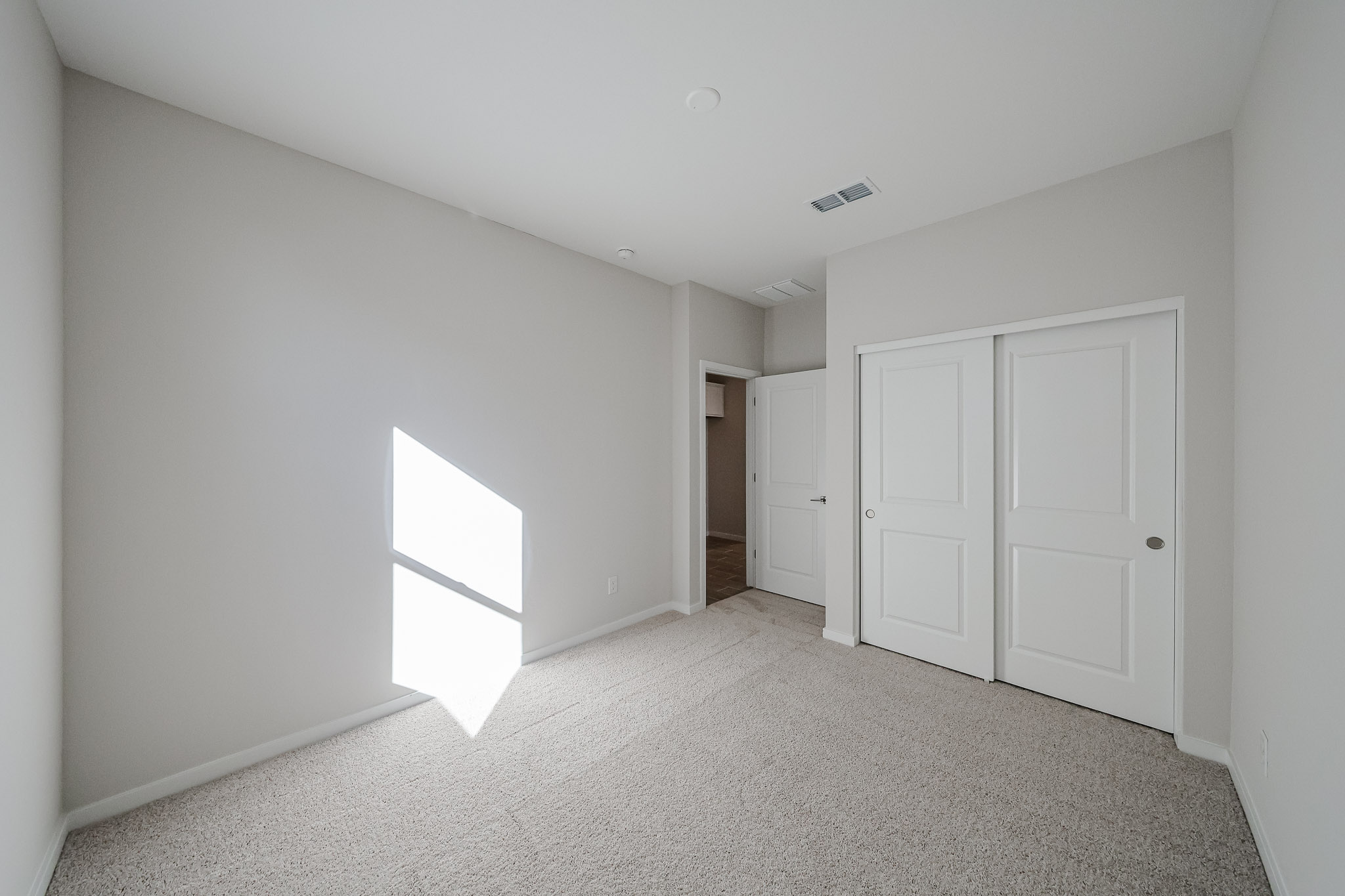 A hallway with white doors.
