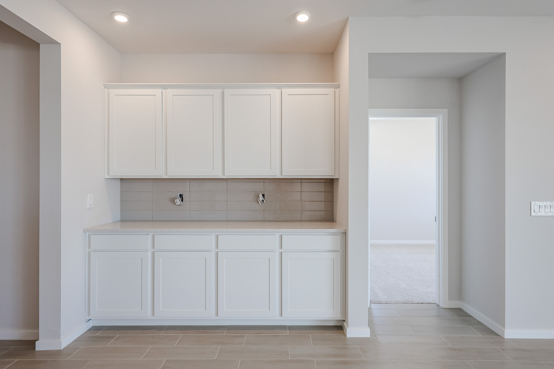 A white kitchen with white cabinets.
