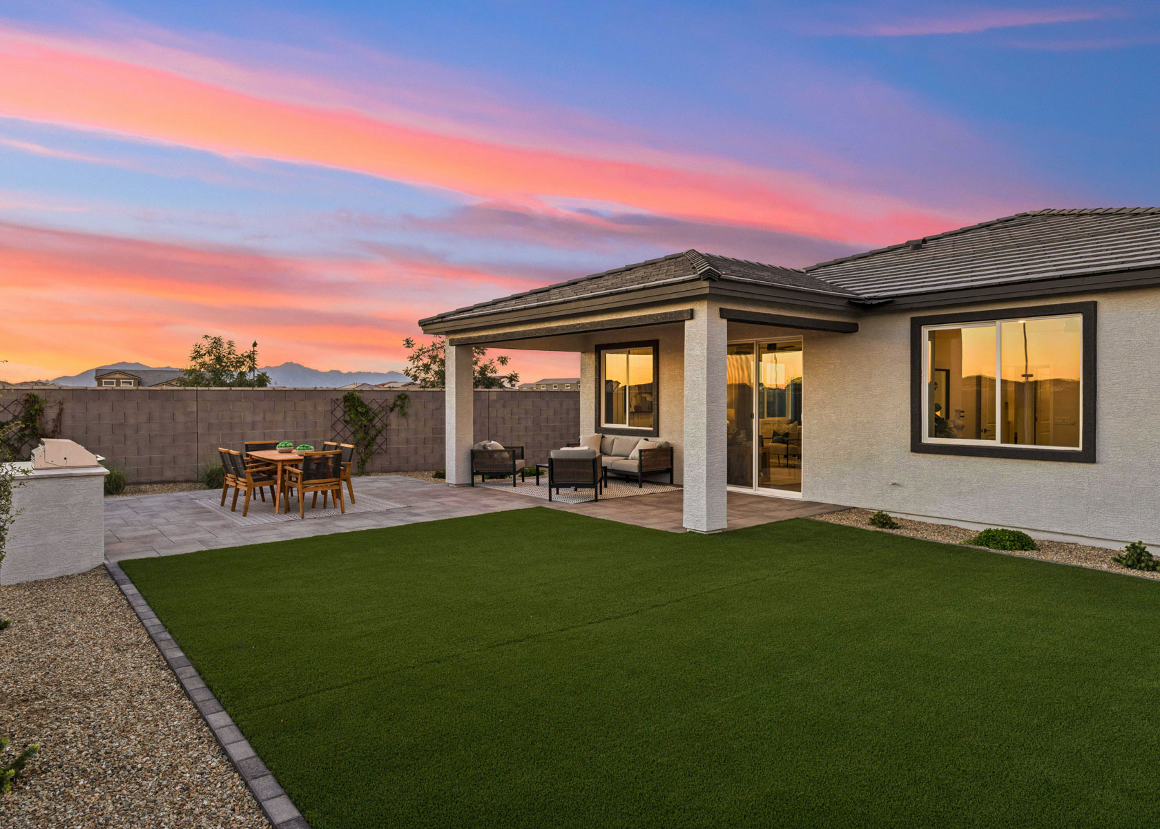 A house with a lawn and chairs.
