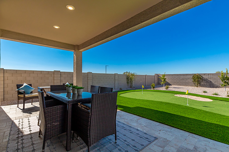 A patio with a table and chairs.