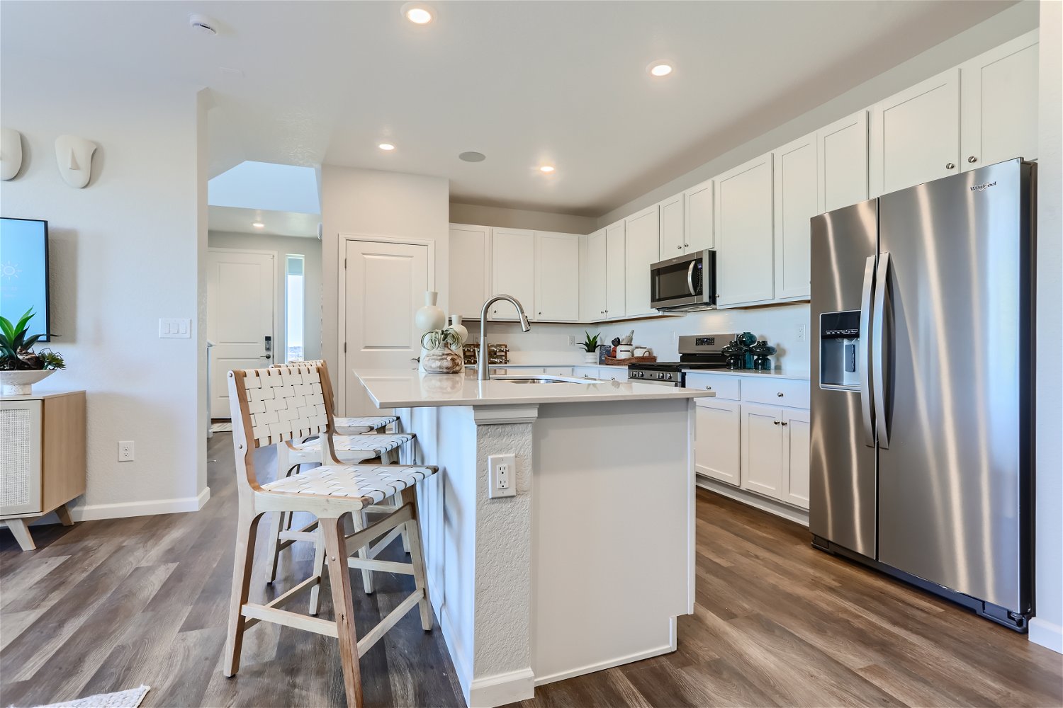A kitchen with white cabinets.