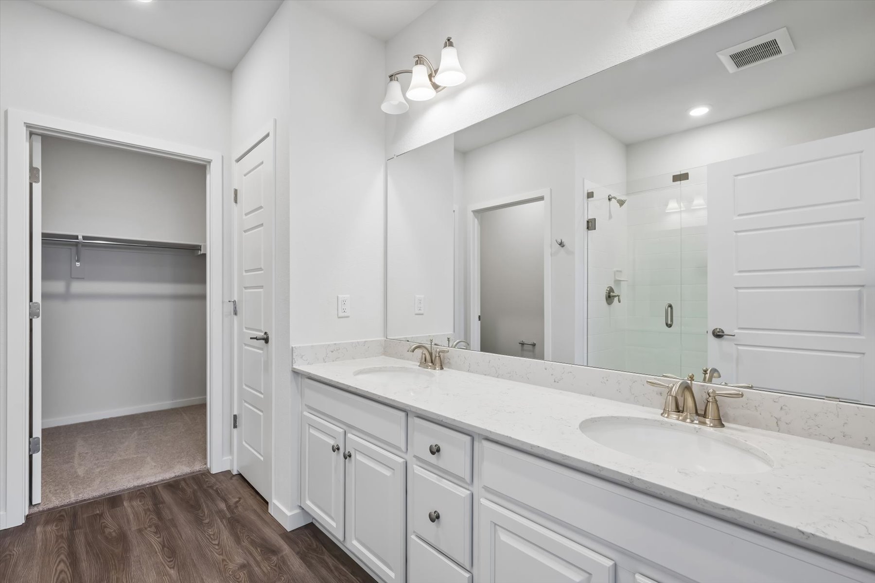 A bathroom with white cabinets.