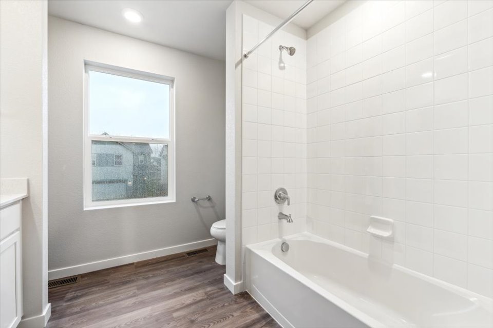 A bathroom with a tub toilet and sink.
