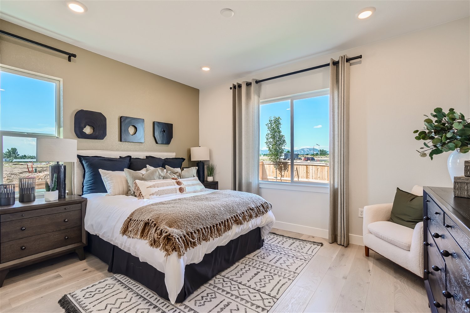 A bedroom with a large window.