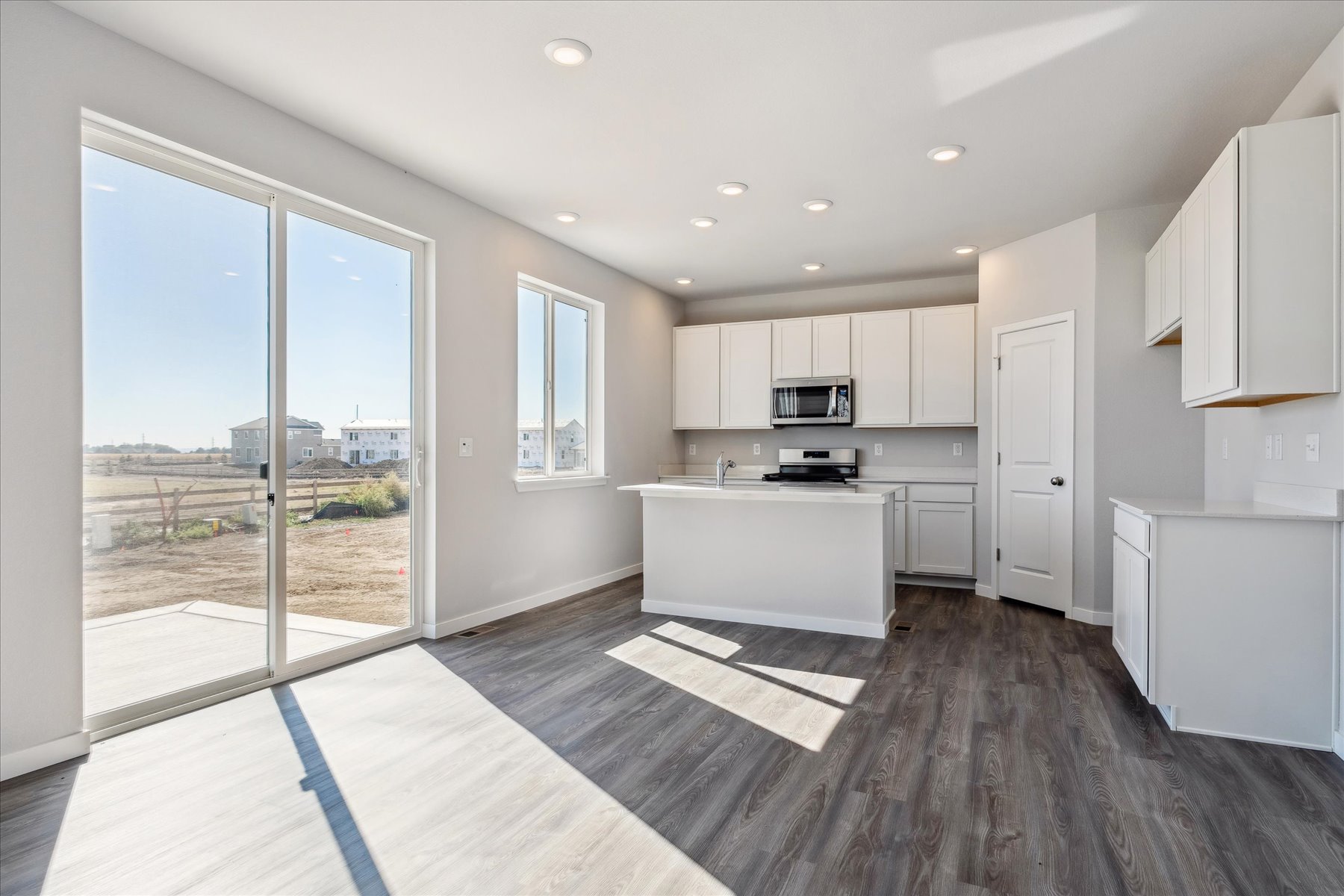 A kitchen with white cabinets.
