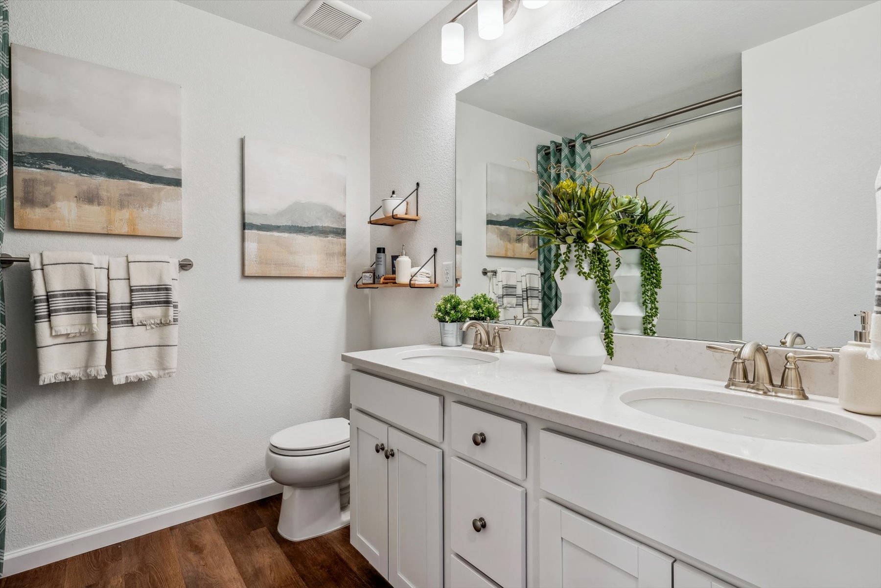 A bathroom with a large mirror.