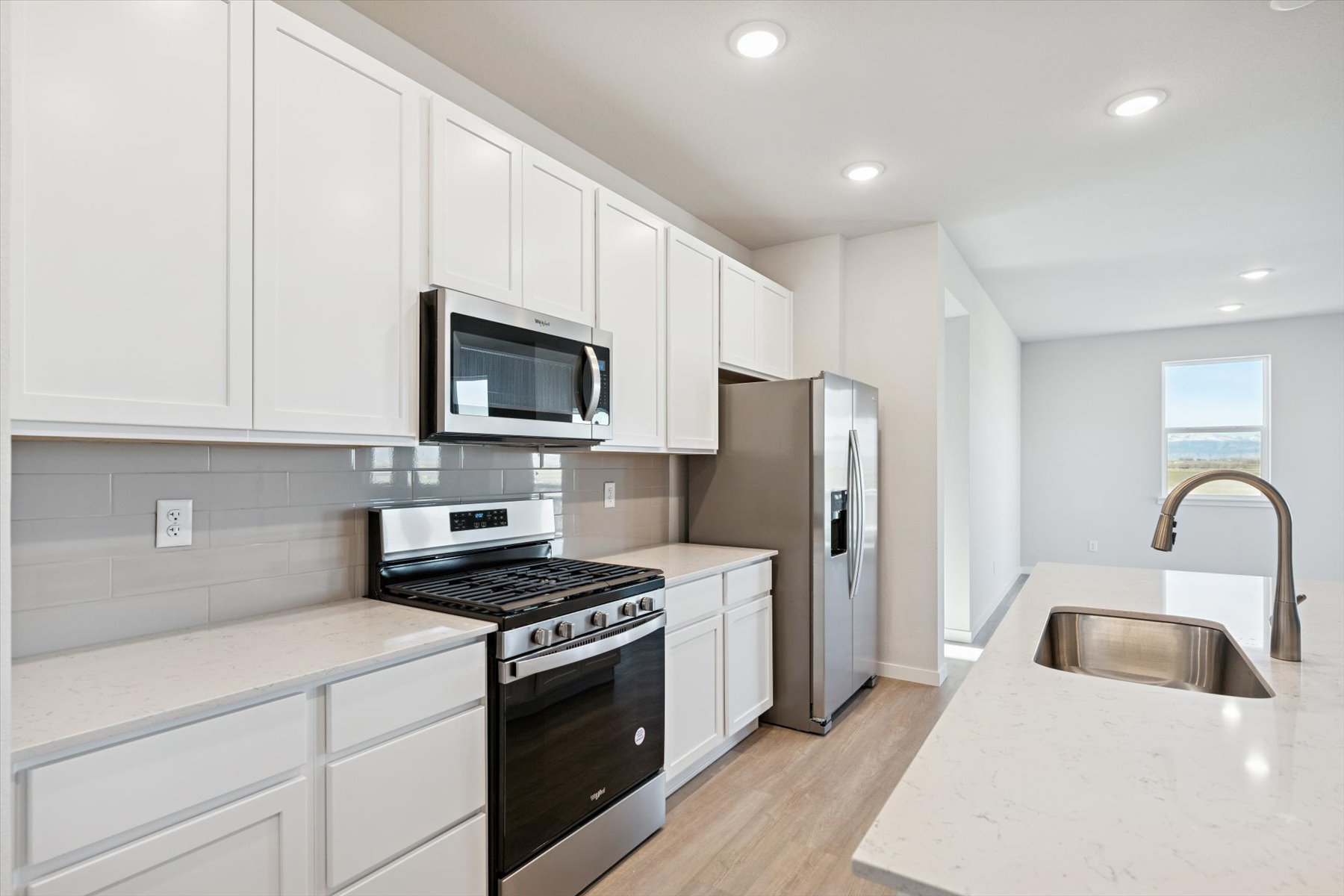 A kitchen with white cabinets.