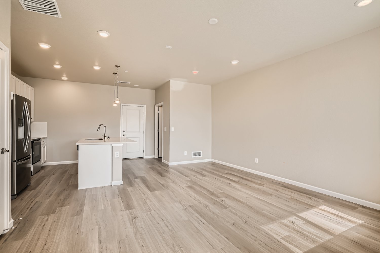 A kitchen with wooden floors.
