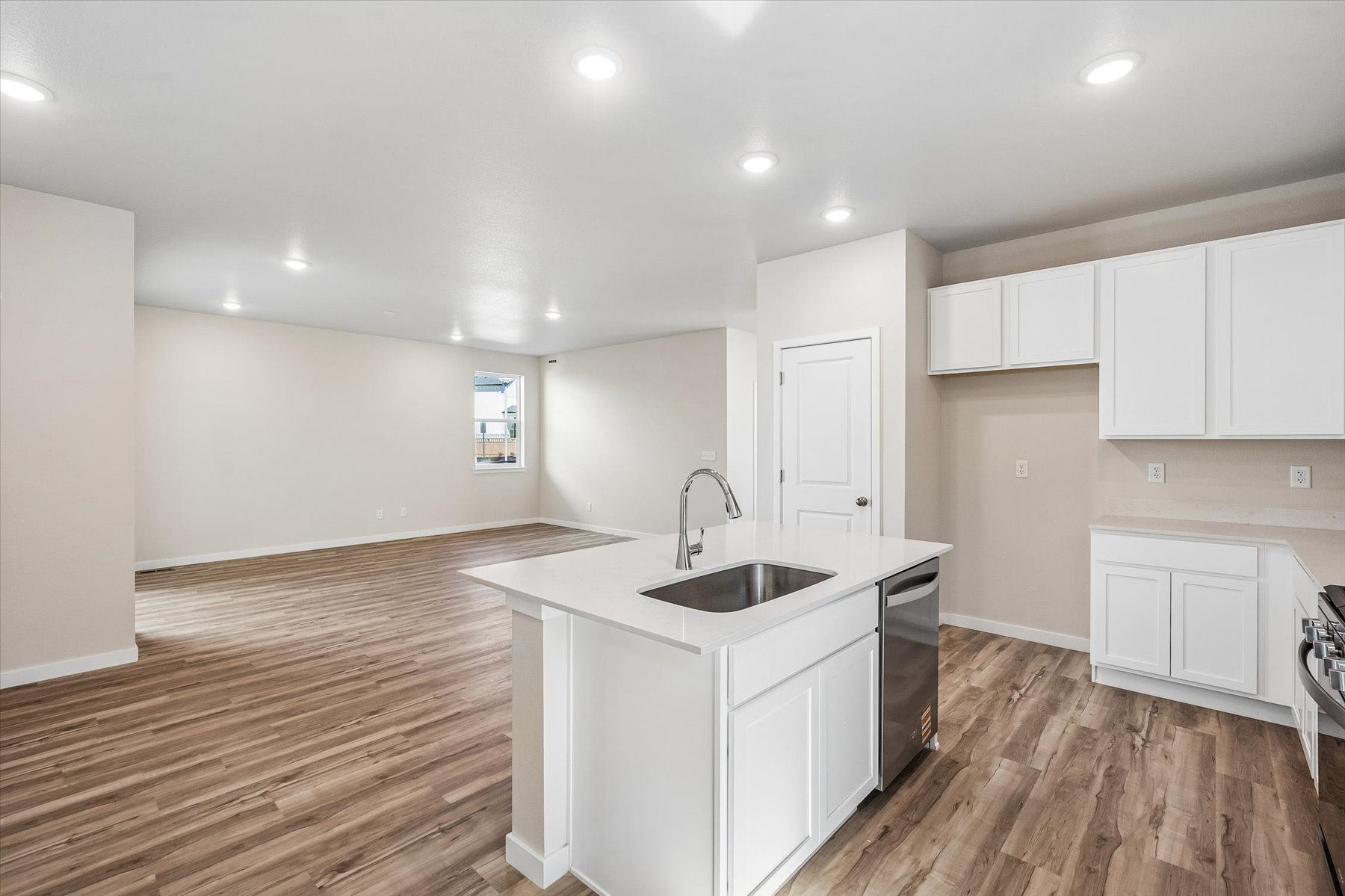 A kitchen with white cabinets.