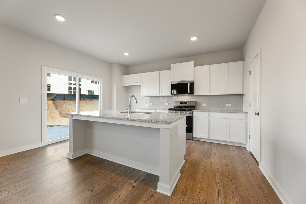 A kitchen with white cabinets.