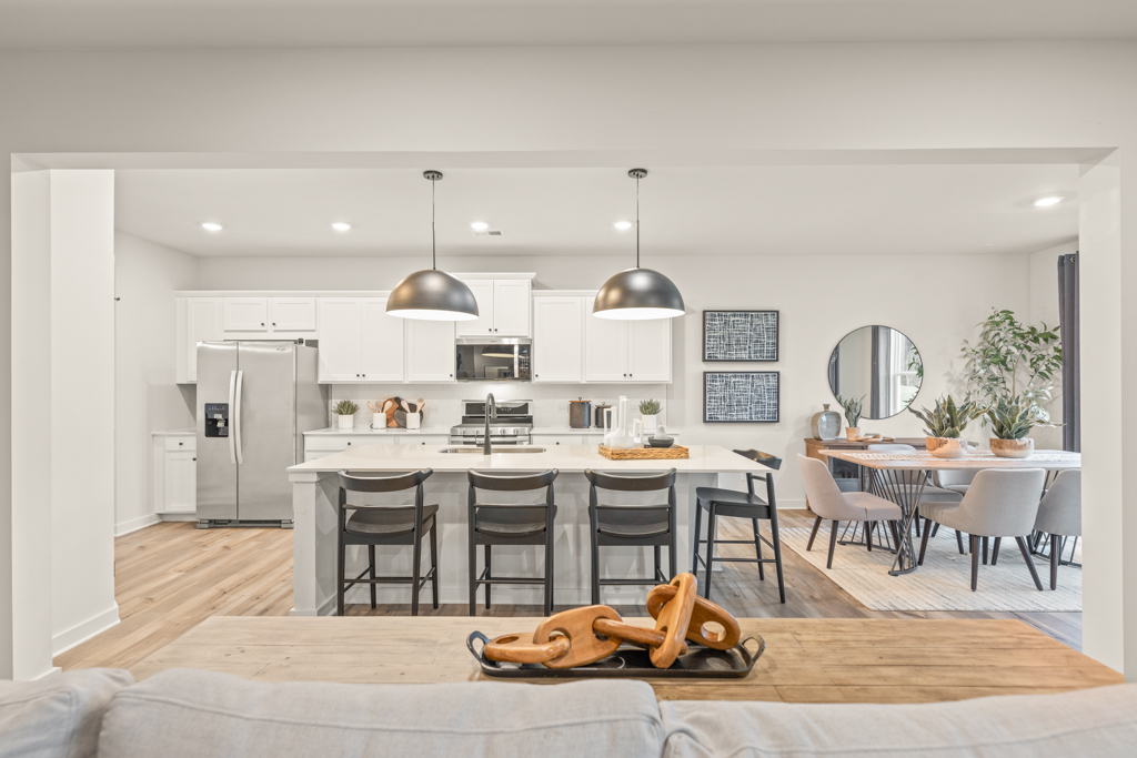 A kitchen with a table and chairs.
