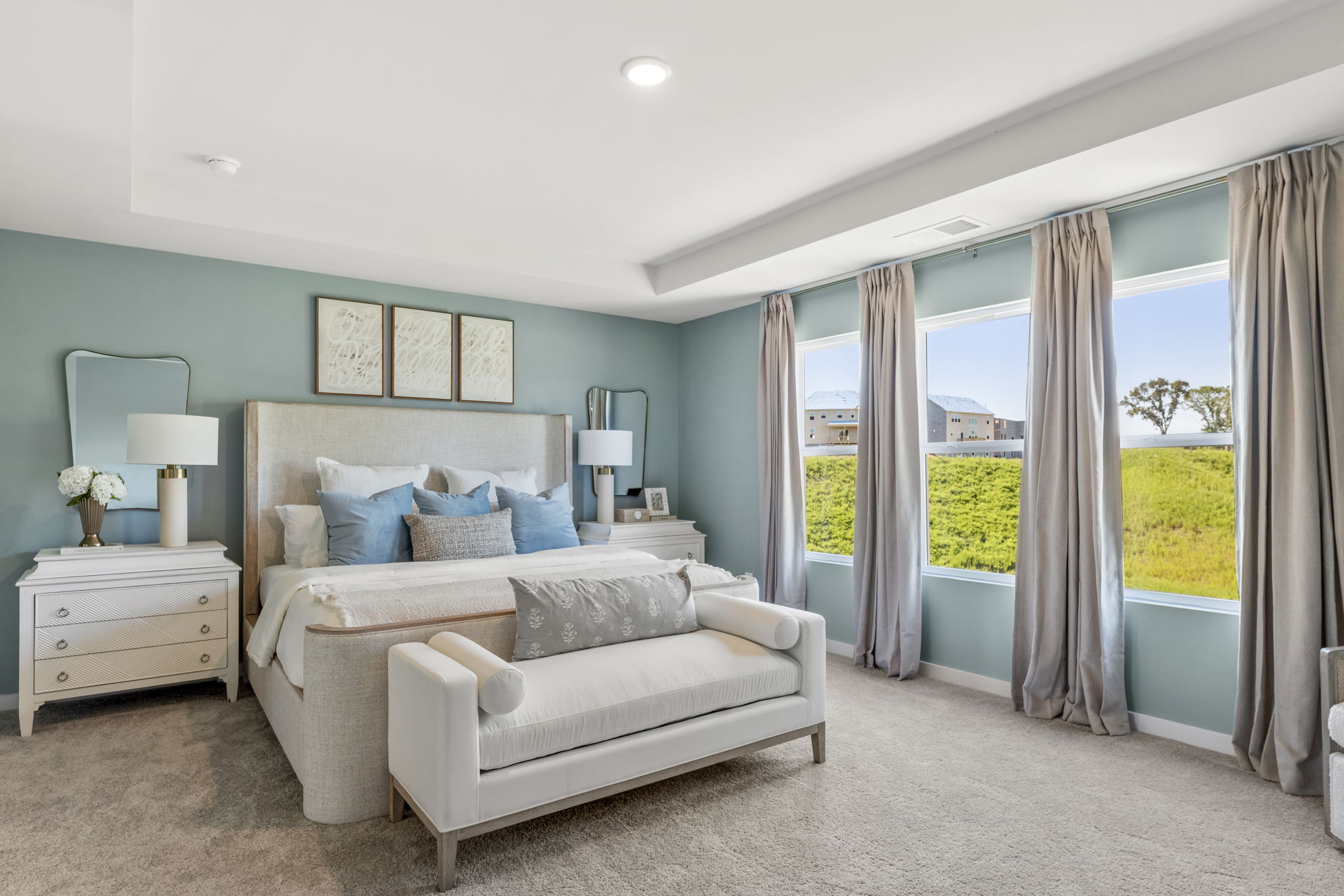 A bedroom with a large window.