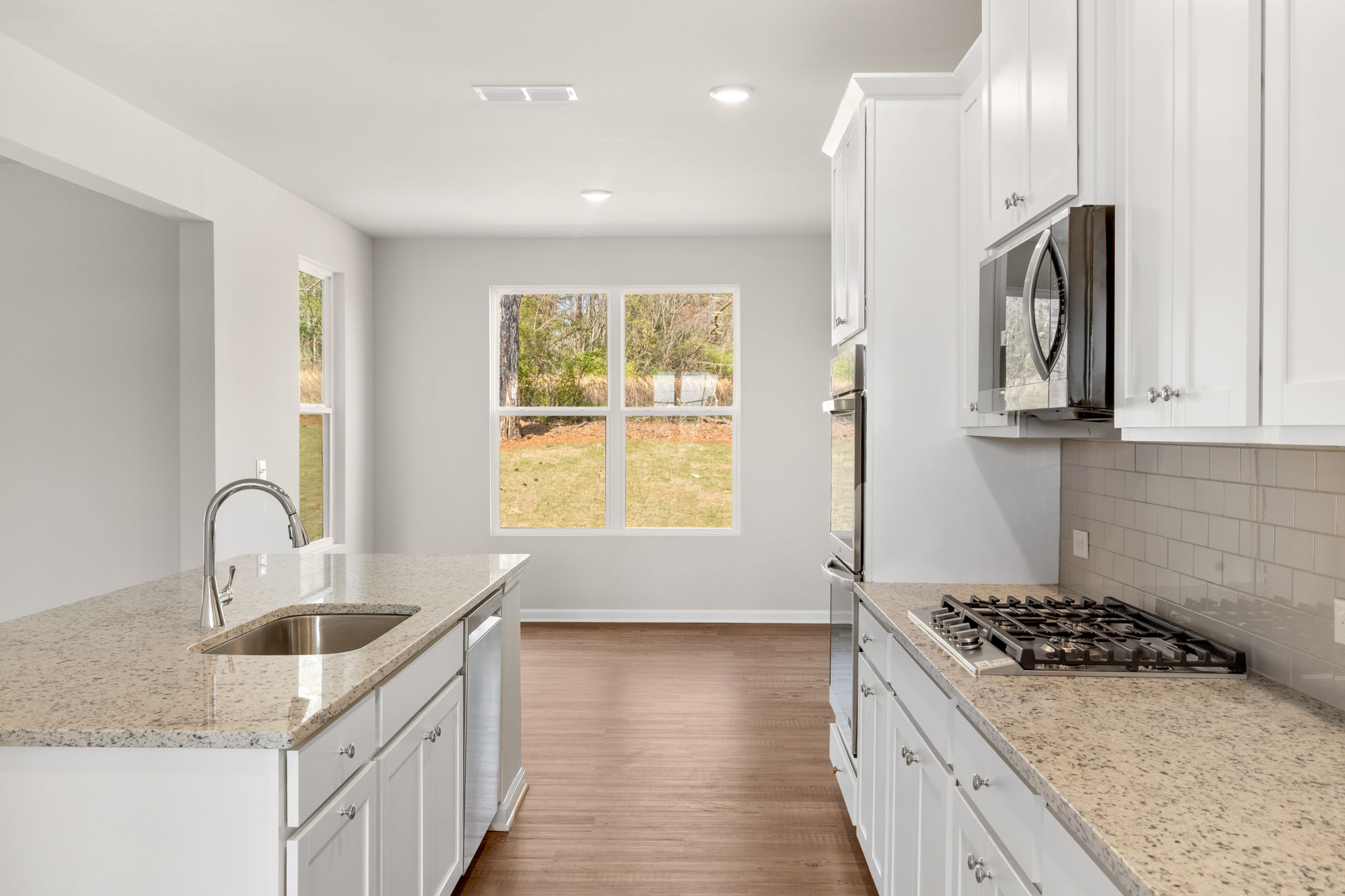 A kitchen with white cabinets.
