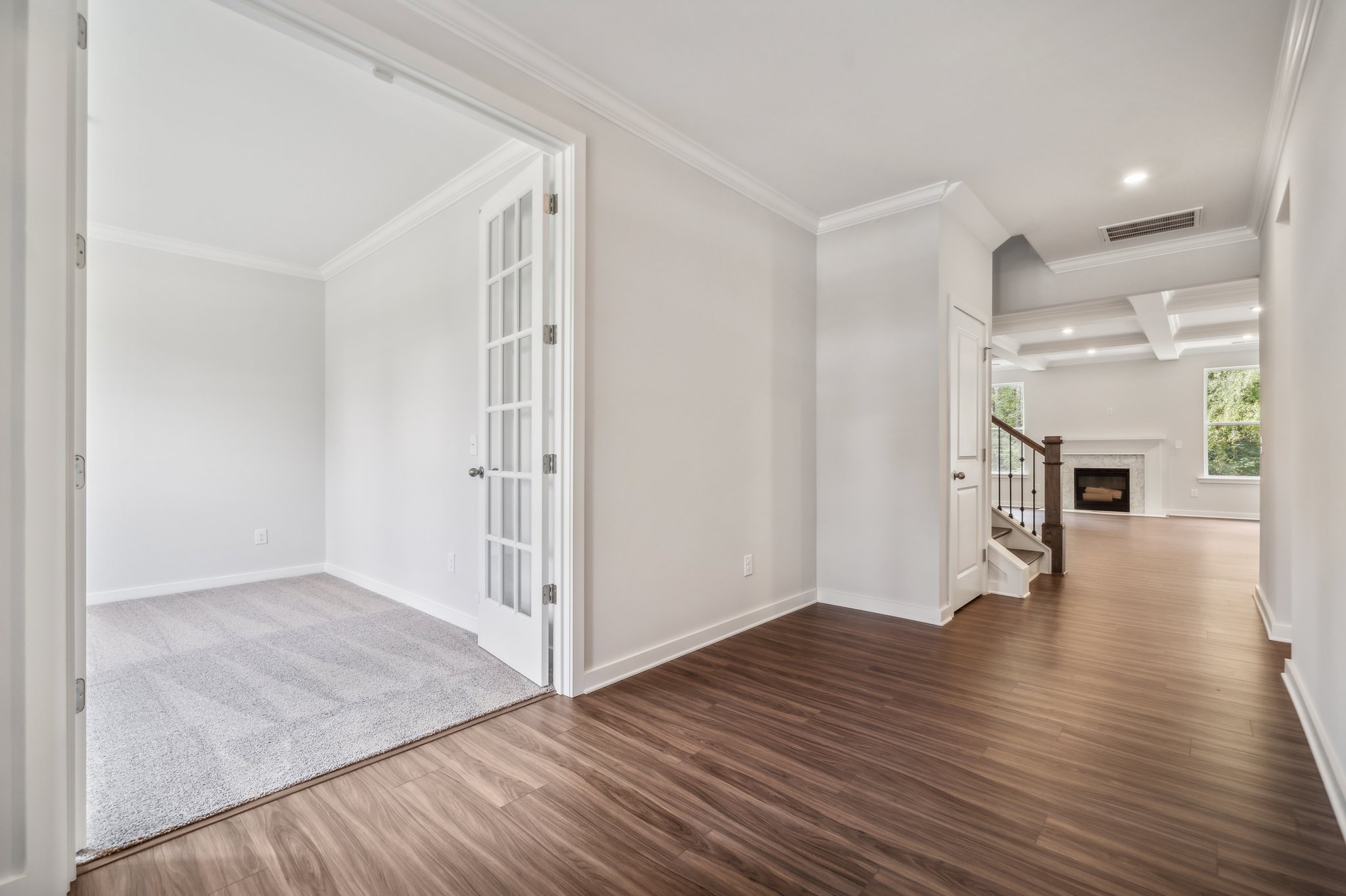 A room with a wood floor and white walls.