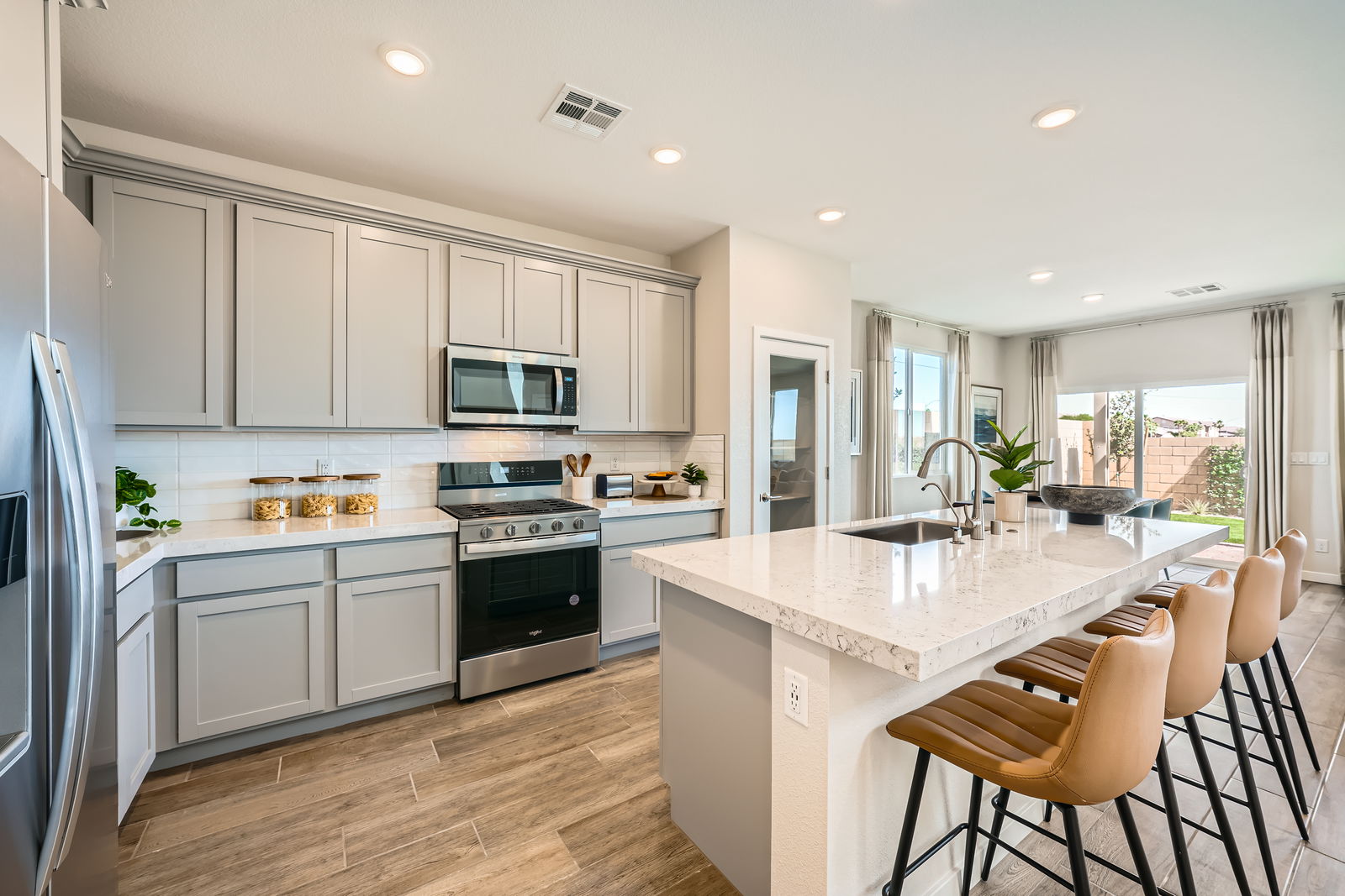 A kitchen with white cabinets.