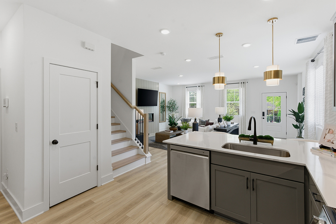 A kitchen with white cabinets.