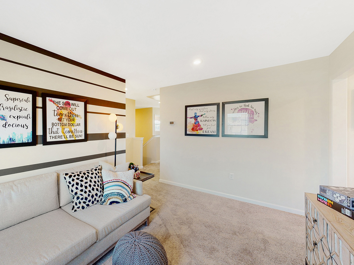 A living room with a couch and a table.