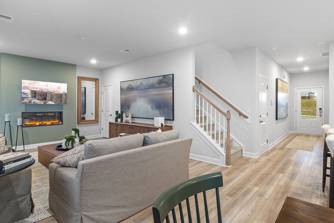 A living room with a staircase.