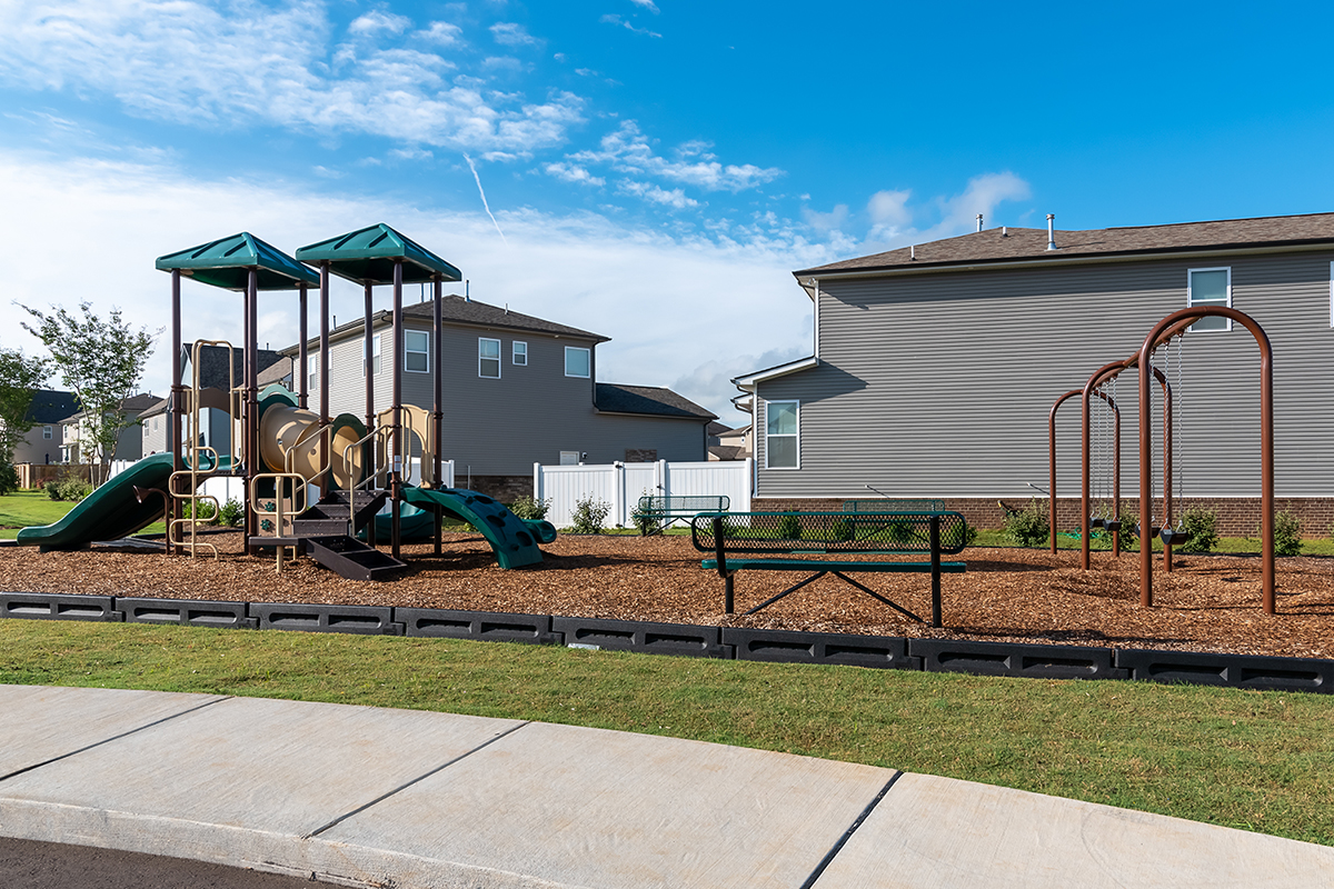 A playground in front of a building.