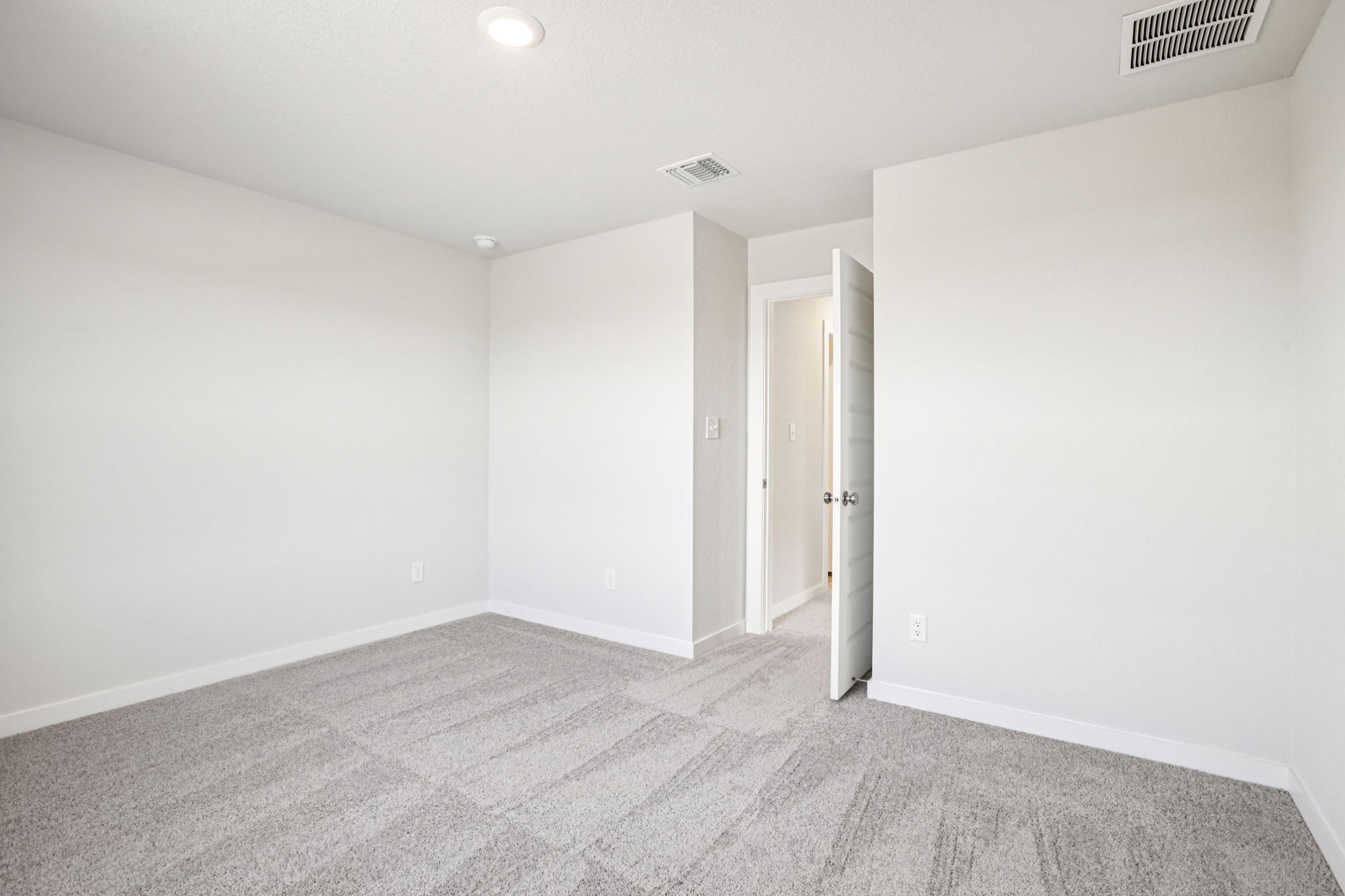 A hallway with white walls.