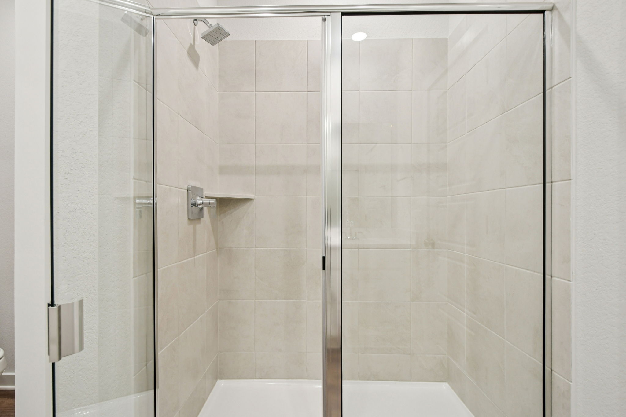 A shower with a glass door.
