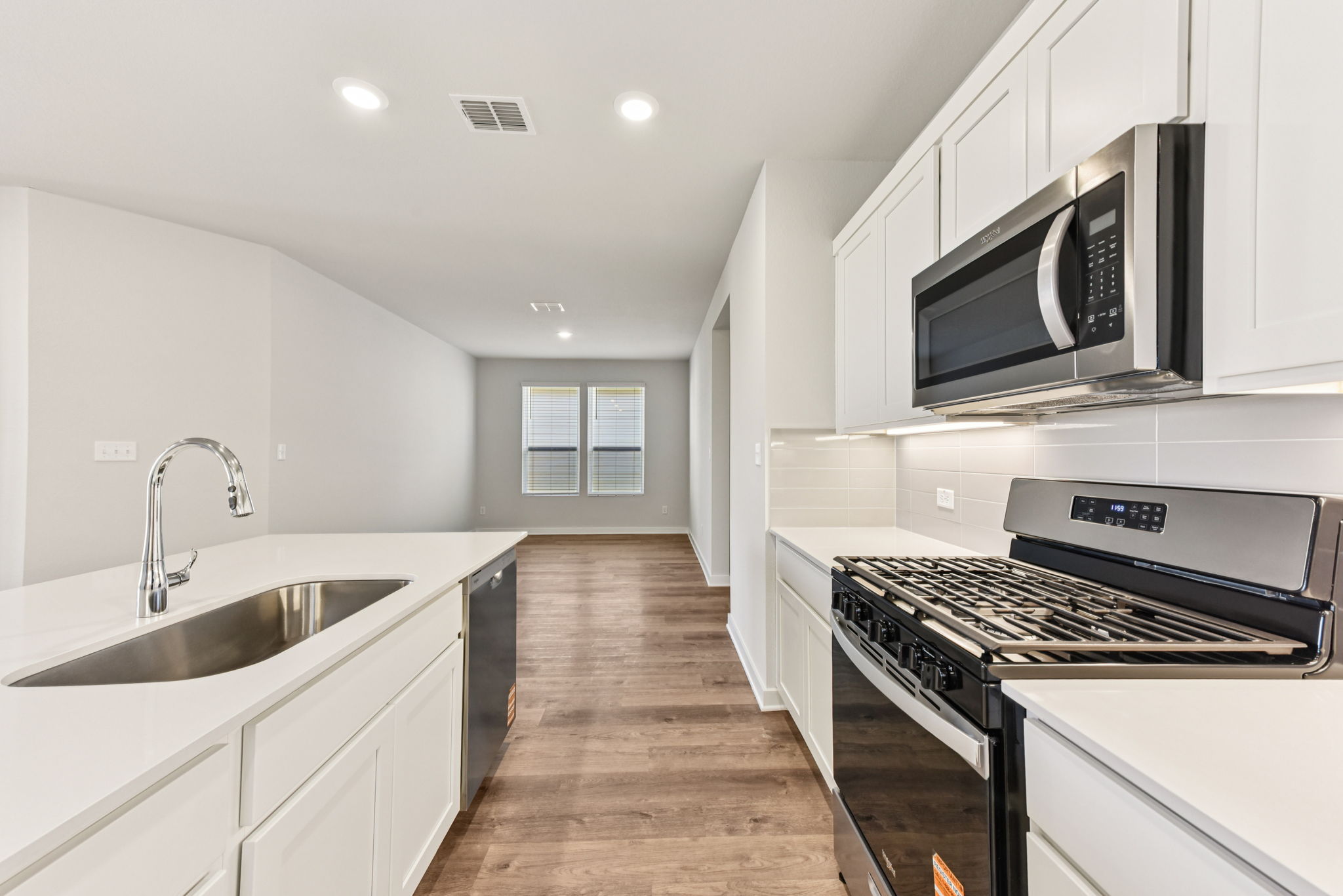 A kitchen with white cabinets.