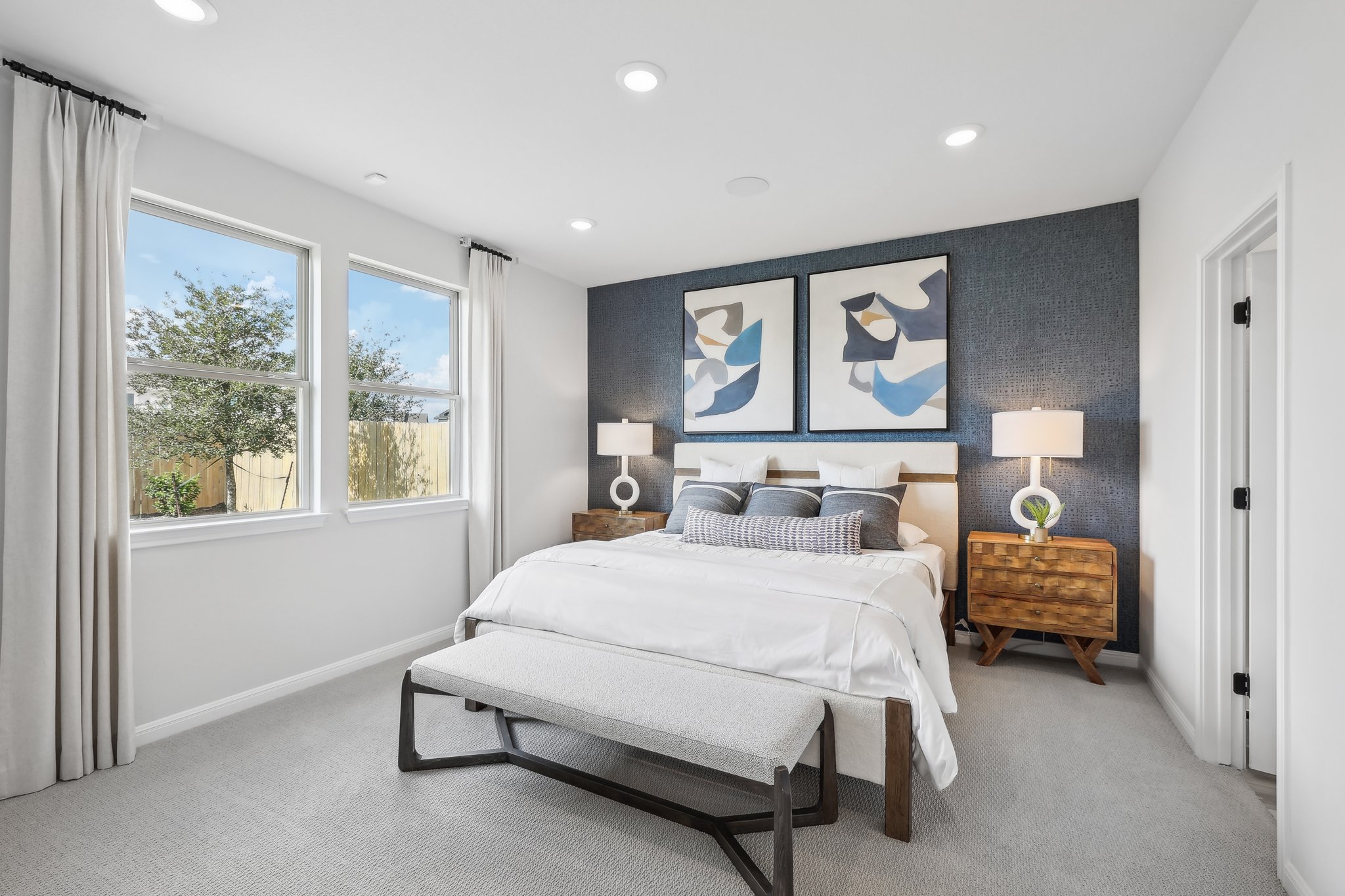 A bedroom with a bed and a bench.