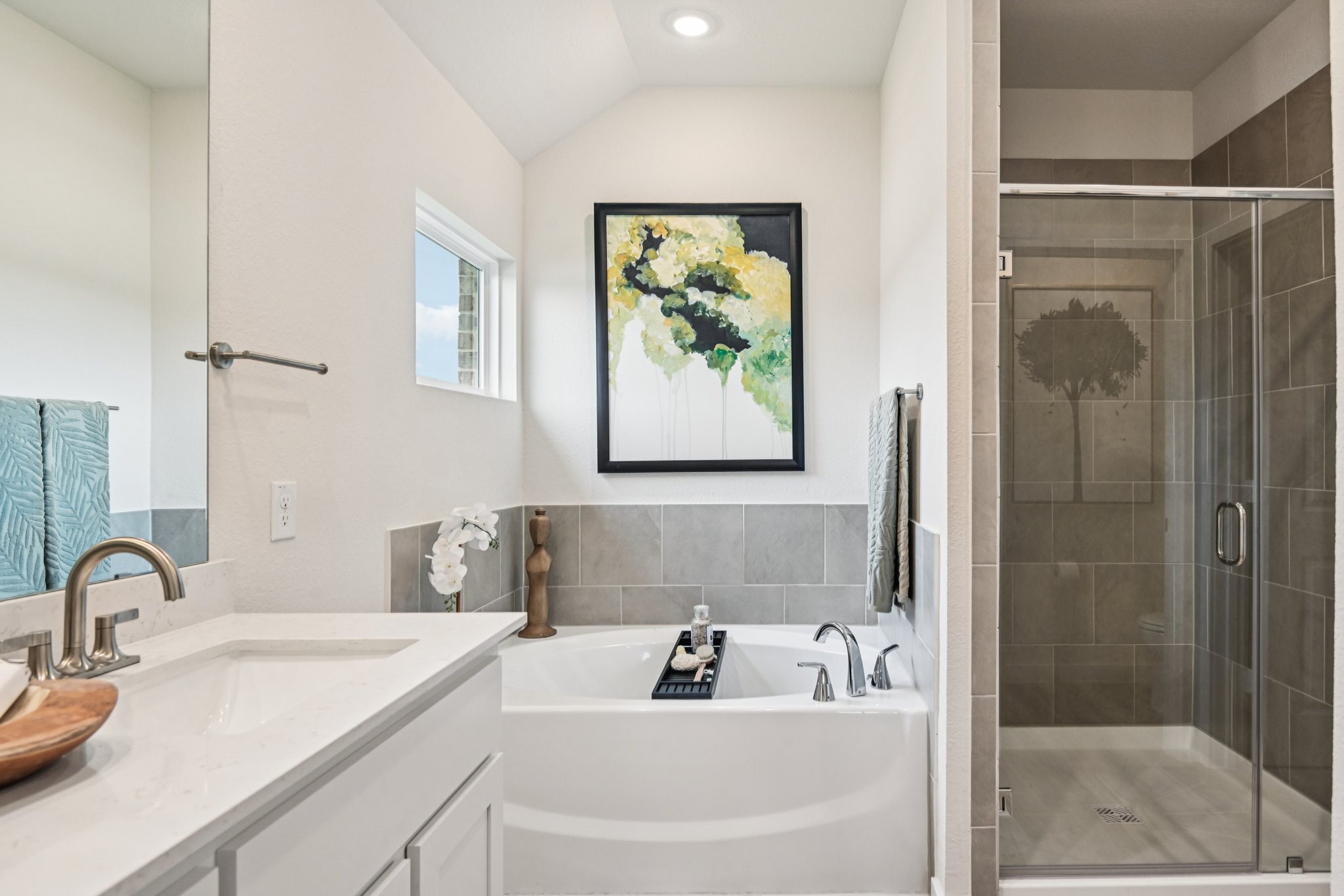 A bathroom with a sink and a shower.