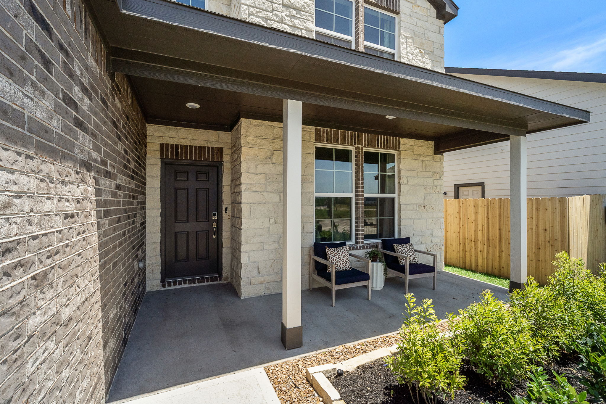 A patio with a table and chairs outside a building.