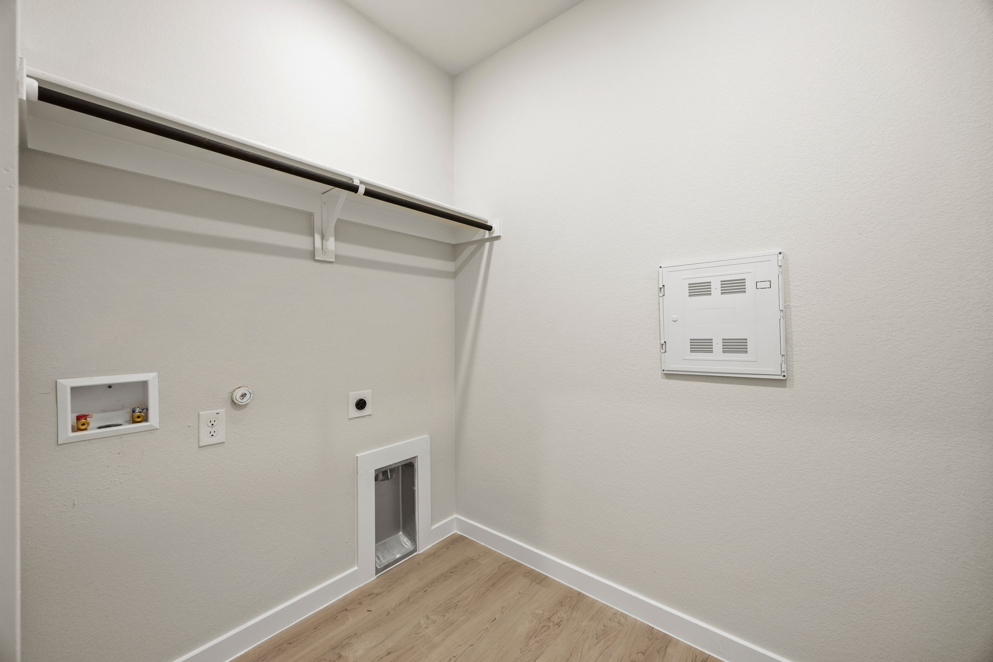 A white wall with a light switch.