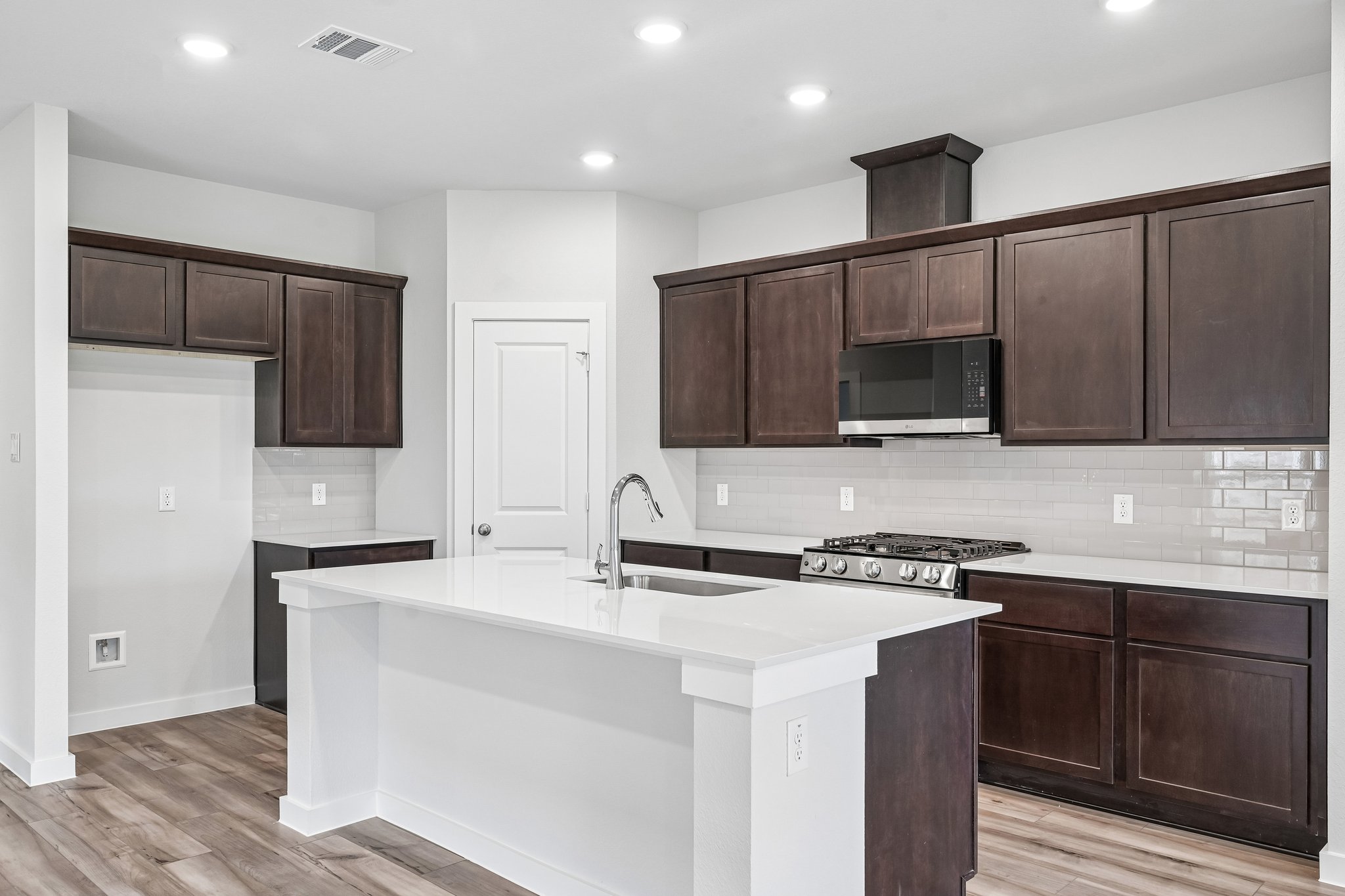 A kitchen with wooden cabinets.